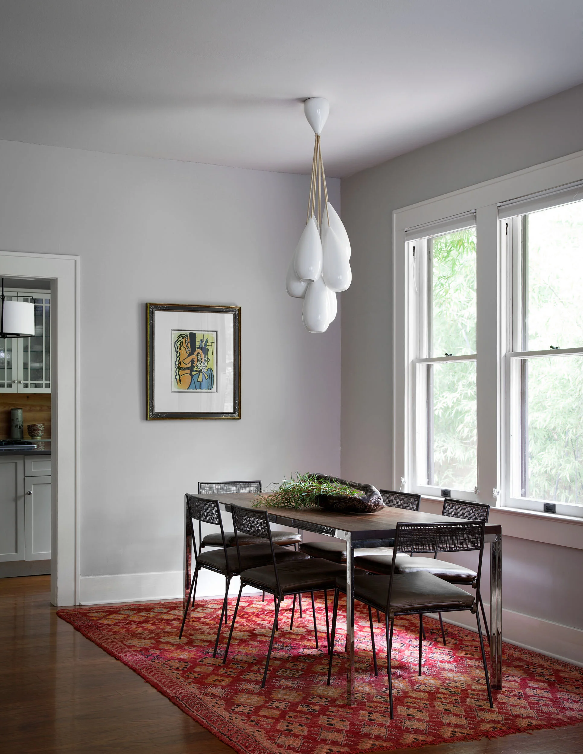  Dining room with art and antiques in the Avenue H Austin home, designed by Mark Cravotta. 