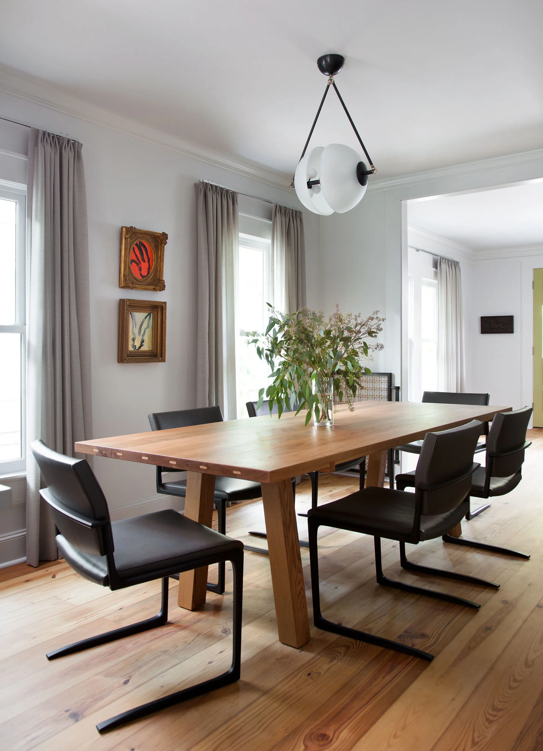  Dining room with custom oak table in the Hyde Park Bungalow, Austin, by Cravotta Interiors. 