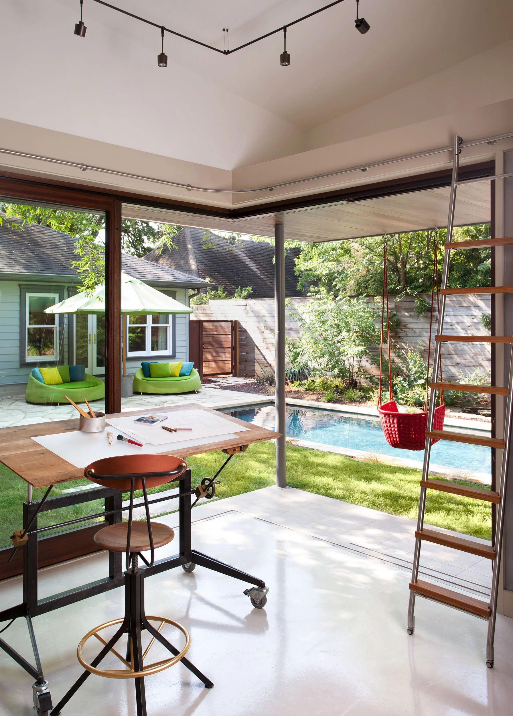  Art studio with custom work table and stool at the Hyde Park Bungalow, designed by Mark Cravotta. 