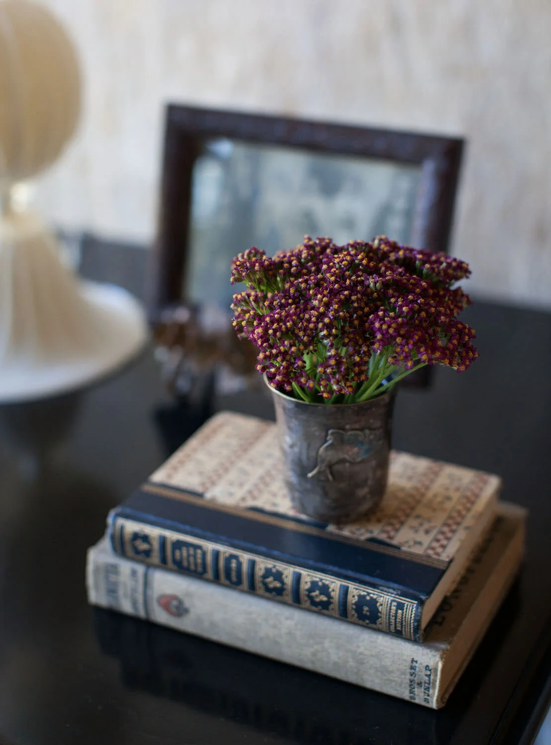  Bedside vignette with antique books and flowers in the Rocky River guest room, designed by Mark Cravotta. 