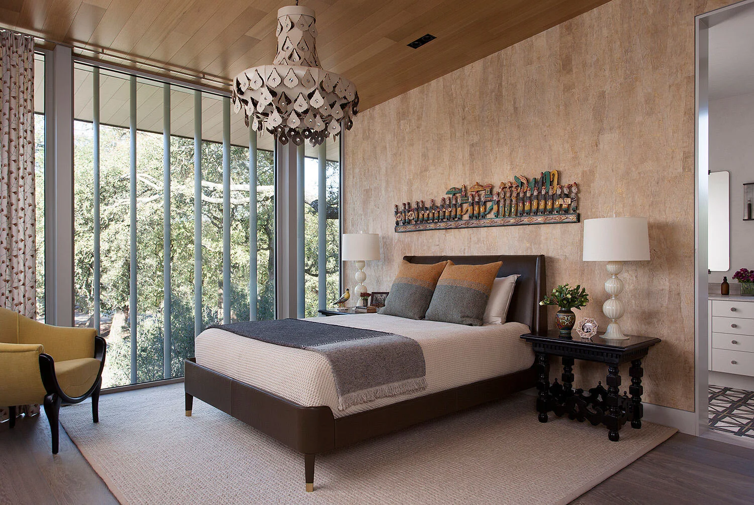  Guest bedroom with wood ceiling, barkcloth wallpaper, leather chandelier, and Holly Hunt bed at Rocky River, designed by Mark Cravotta. 