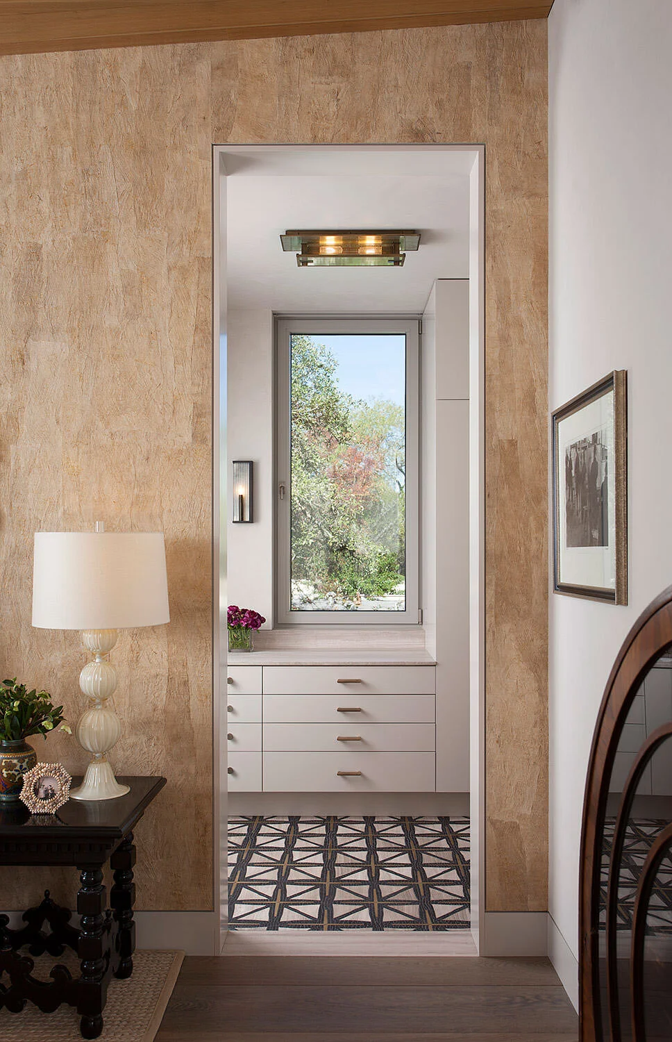  View from the Rocky River guest bedroom through to the bathroom with custom mosaic tile floor by Cravotta Interiors. 