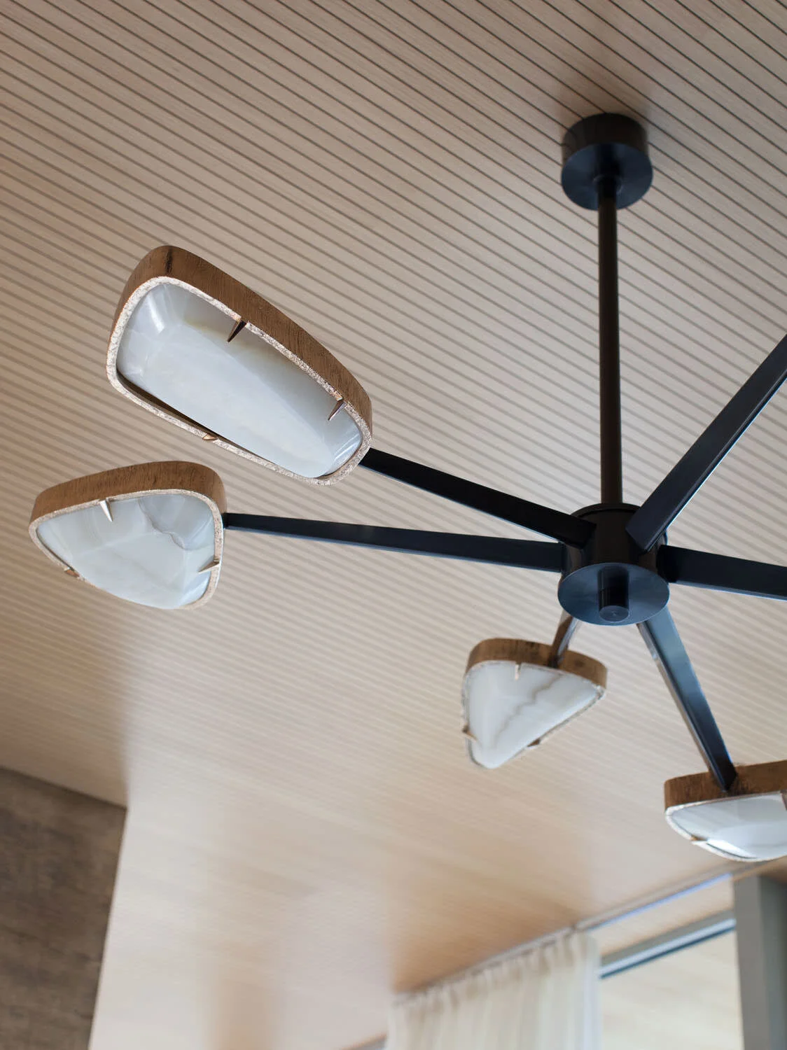  Achille Salvagni bronze and quartz chandelier against the wood ceiling at Rocky River by Cravotta Interiors. 