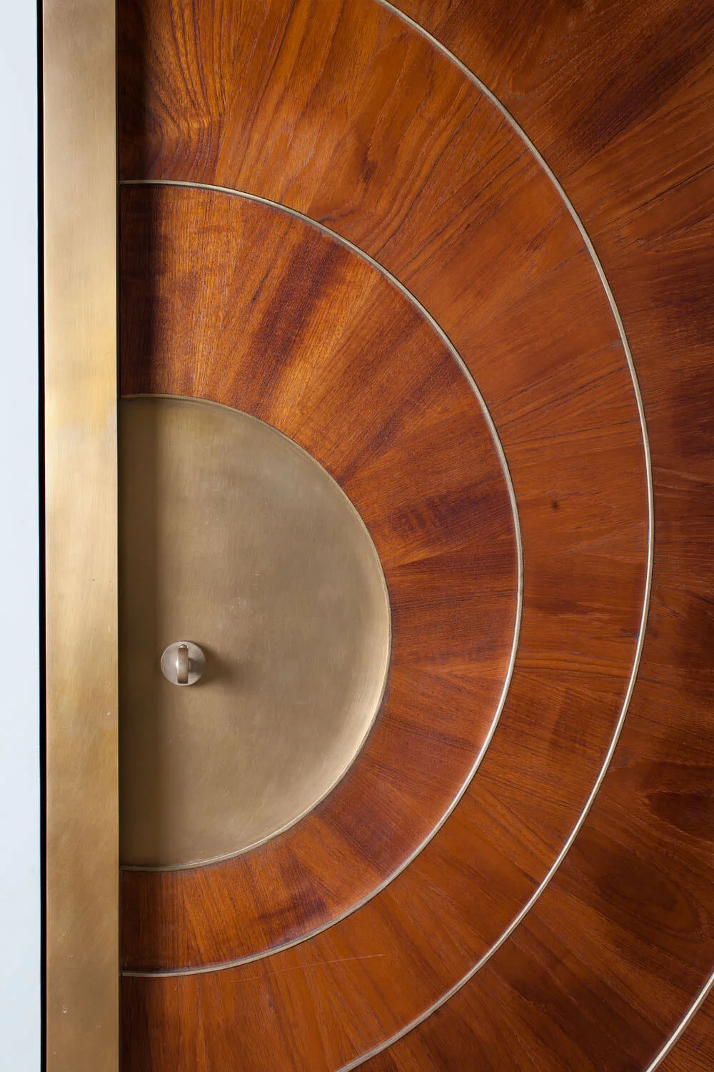  Close-up of the handmade teak and bronze entry door hardware at Rocky River by Cravotta Interiors. 