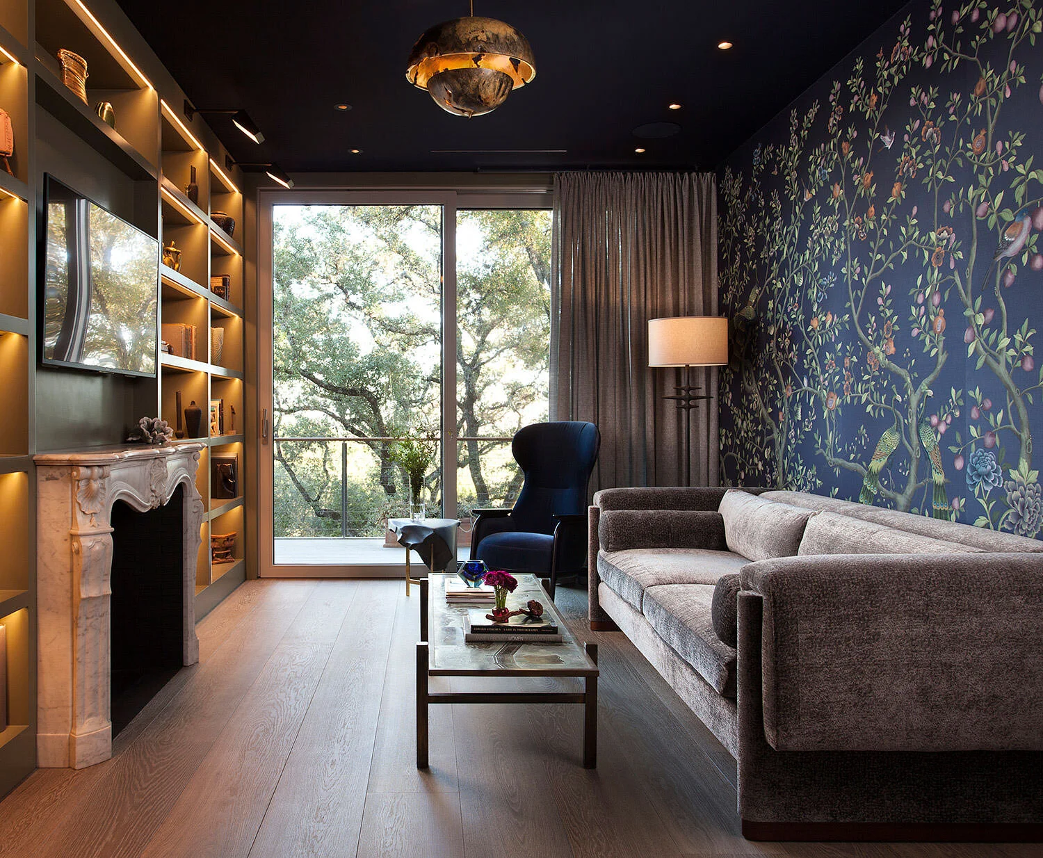  Full view of the Rocky River library showing the silk wallpaper, seating, and antique mantel by Cravotta Interiors. 