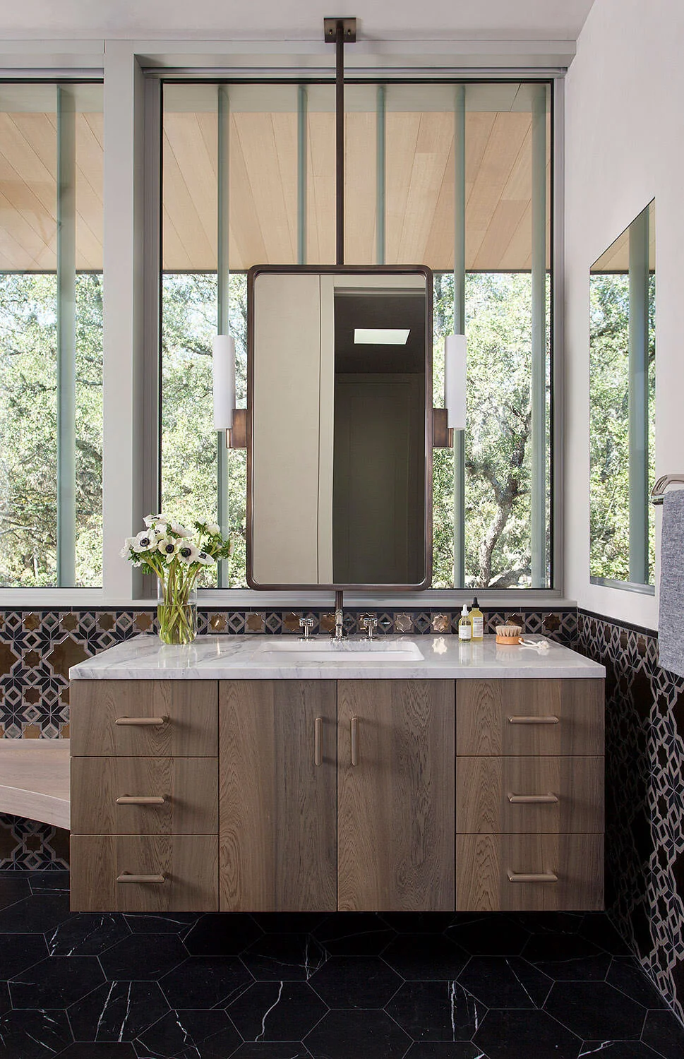  Custom vanity with floating mirrors and Moroccan mosaic tile in the Rocky River primary bath, designed by Mark Cravotta. 