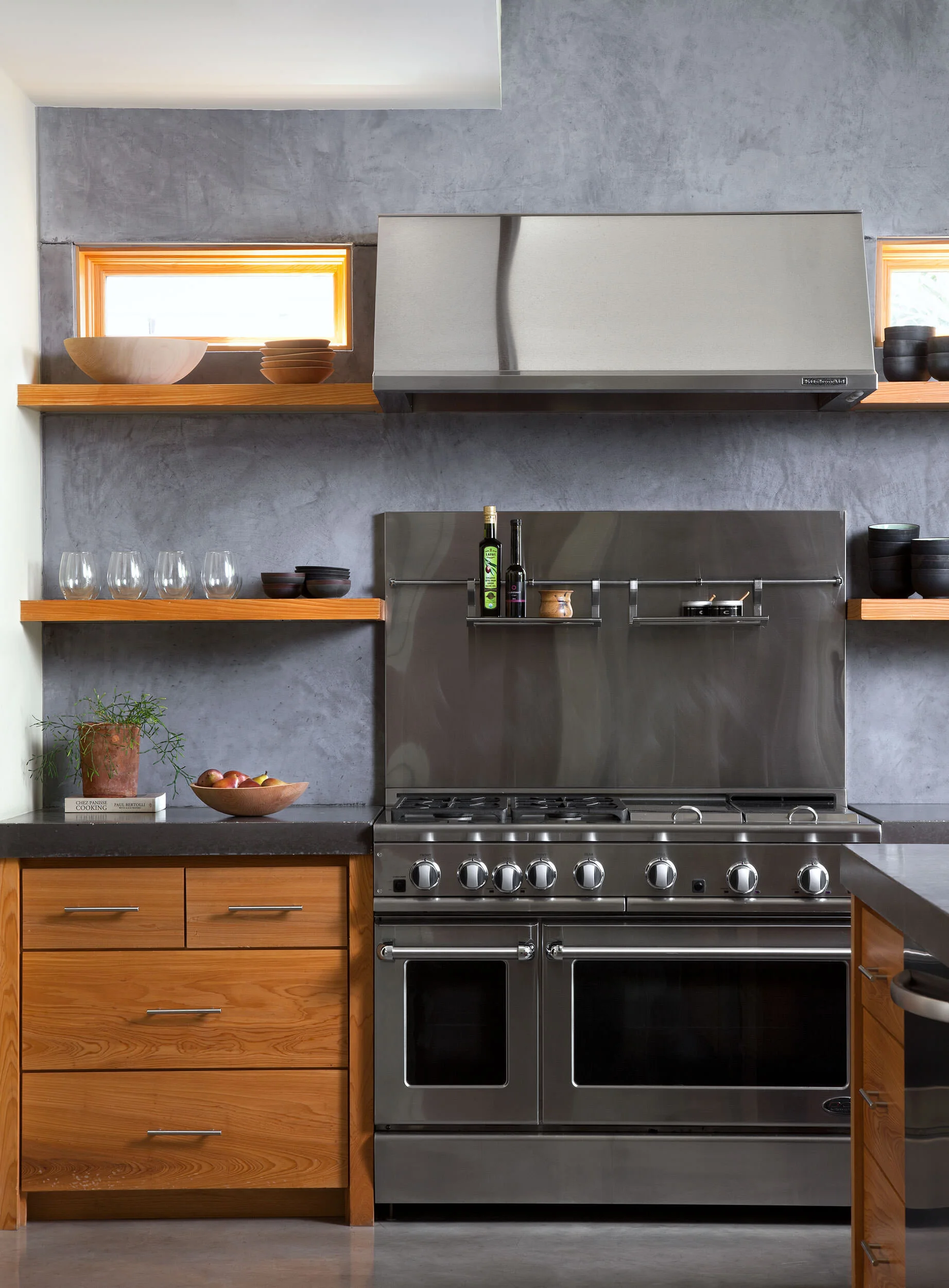 Kitchen with concrete plaster walls, cypress cabinets, and commercial-grade appliances at Zilker Contemporary, designed by Mark Cravotta. 
