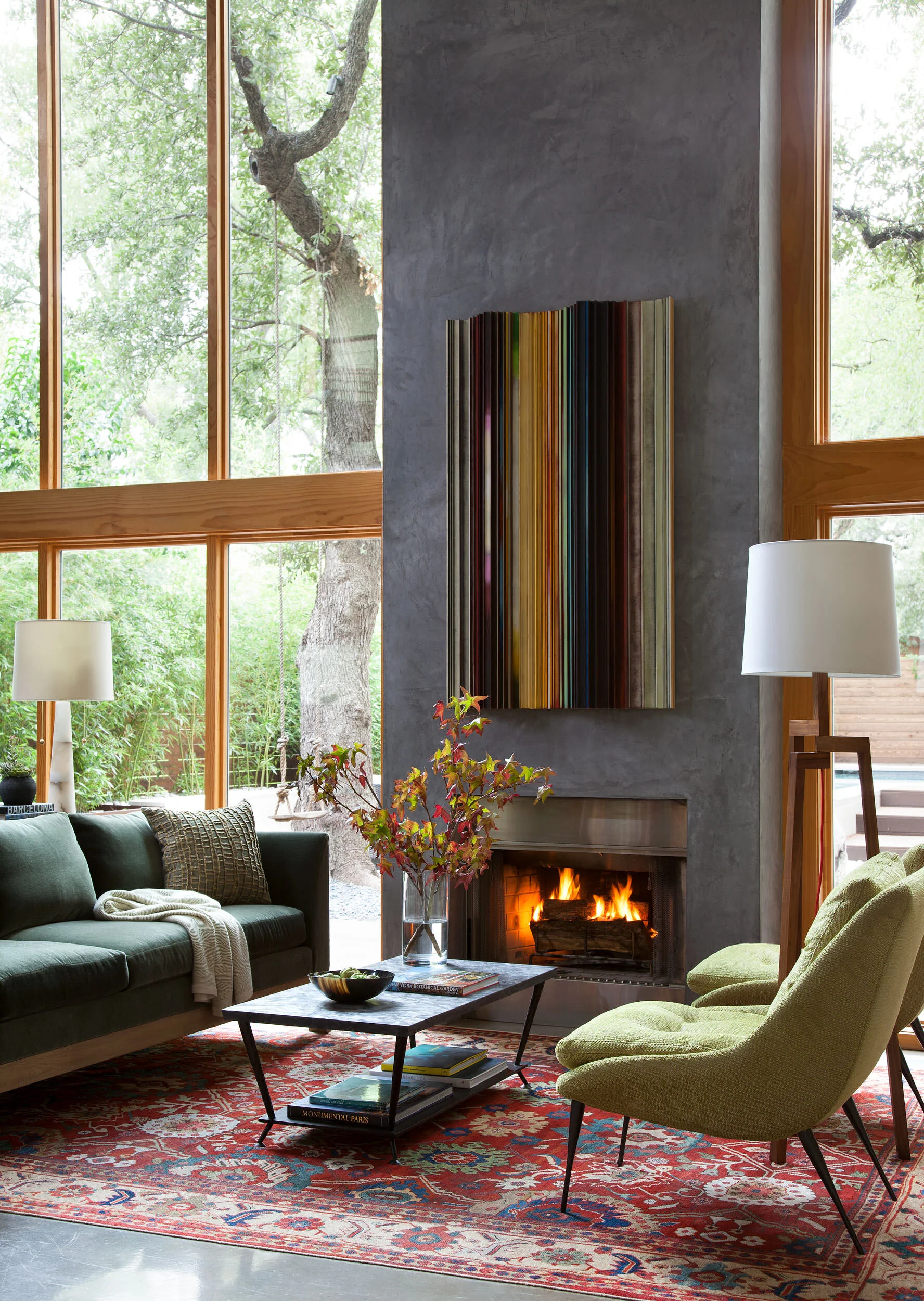  Living room fireplace with cypress millwork and antique rug at Zilker Contemporary, designed by Mark Cravotta. 