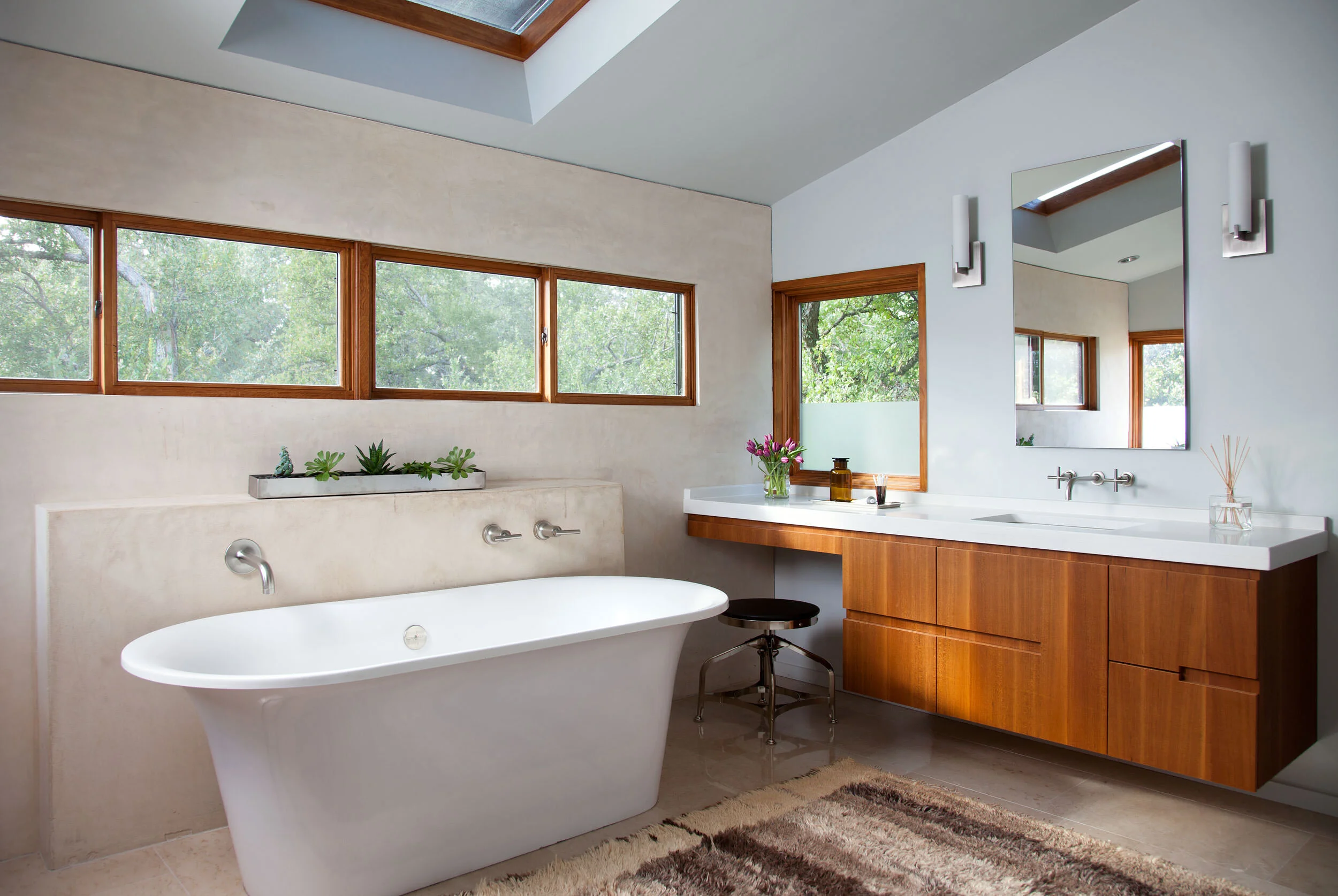  Bathroom with plaster walls, cypress millwork, and antique rug at Zilker Contemporary, designed by Mark Cravotta. 