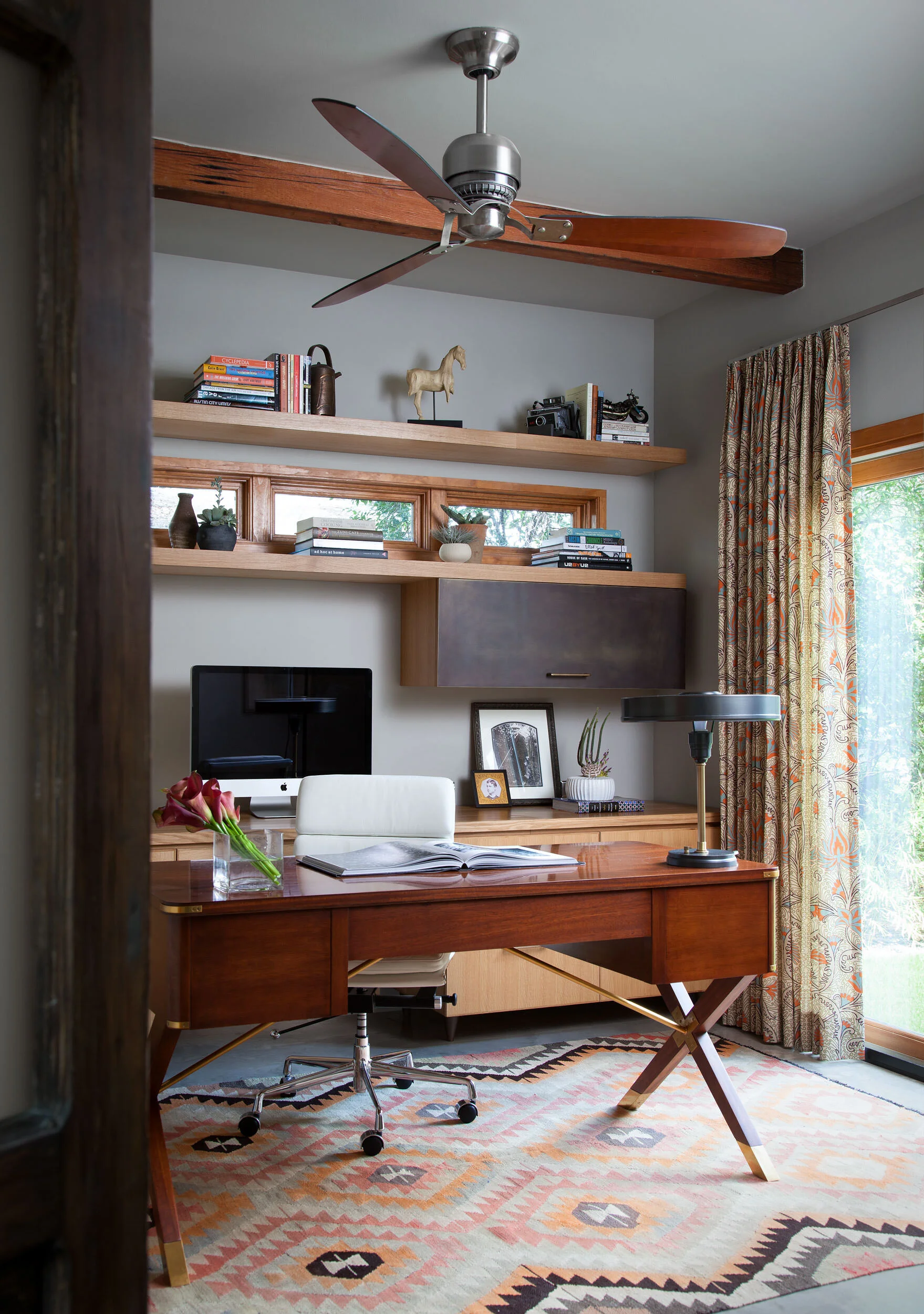  Office with custom oak millwork and antique rug at the Zilker Contemporary home by Cravotta Interiors. 