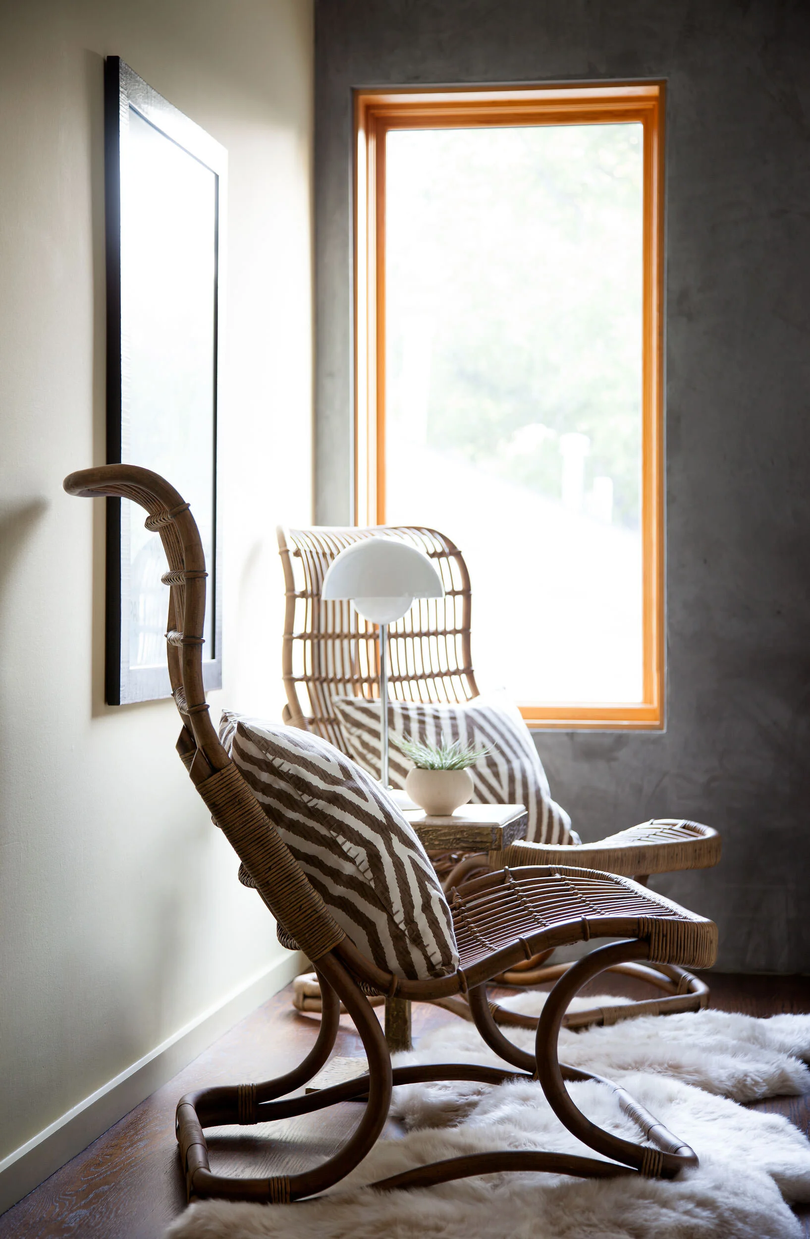  Casual rattan chairs against plaster walls at Zilker Contemporary, designed by Mark Cravotta. 