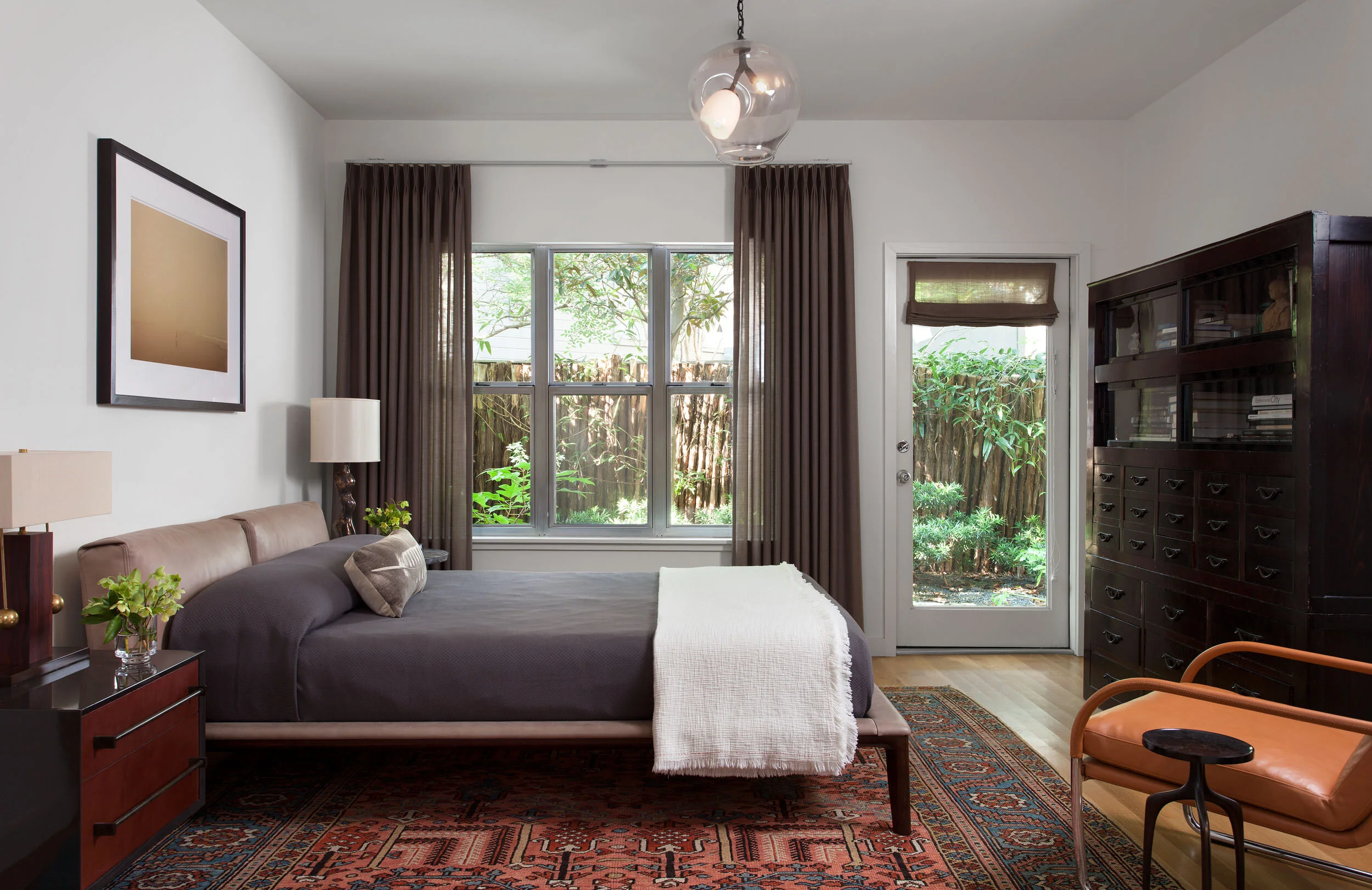  Bedroom with leather bed and wool sheer drapes at Clarksville, Austin, designed by Mark Cravotta. 