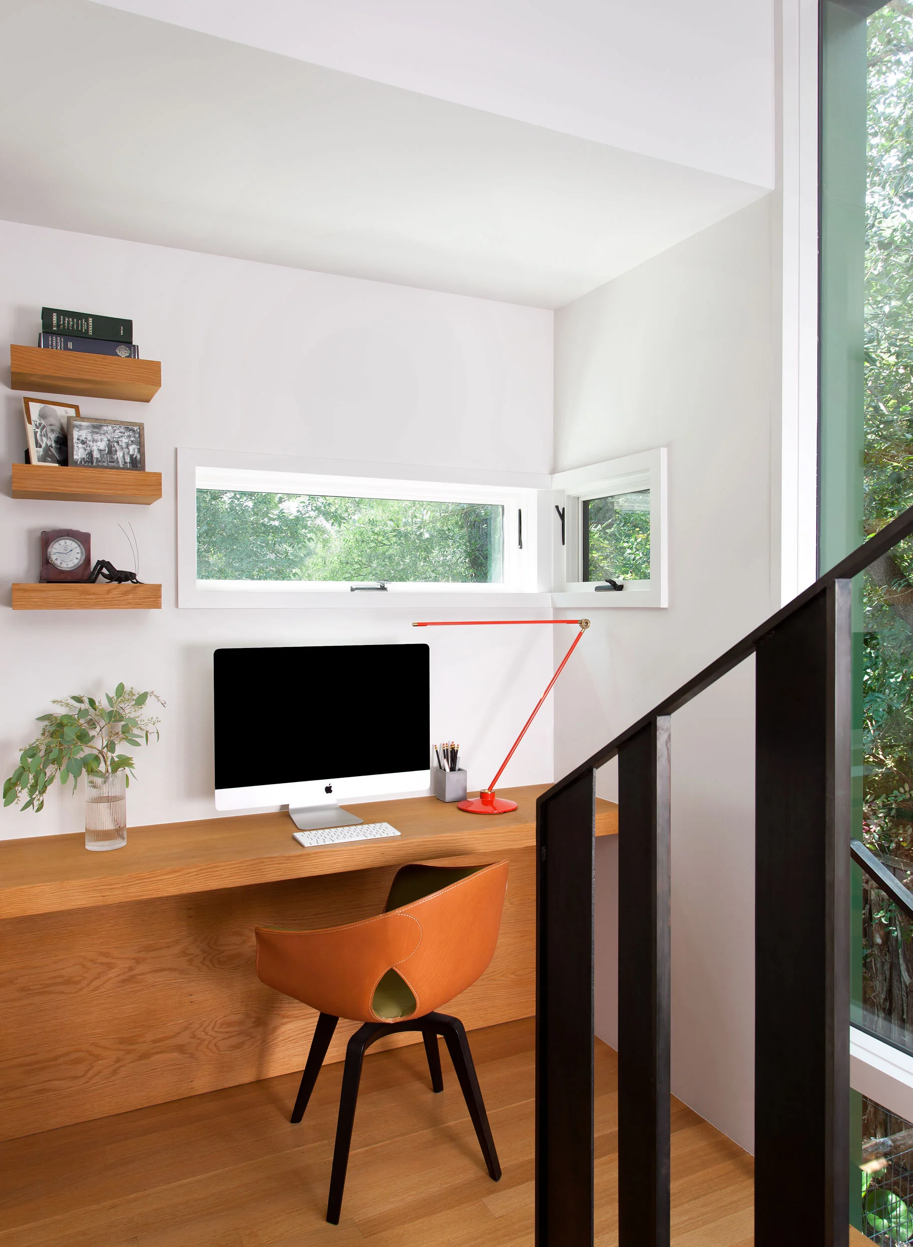  Stair landing desk with sculptural stairs and concrete floors at Clarksville by Cravotta Interiors. 