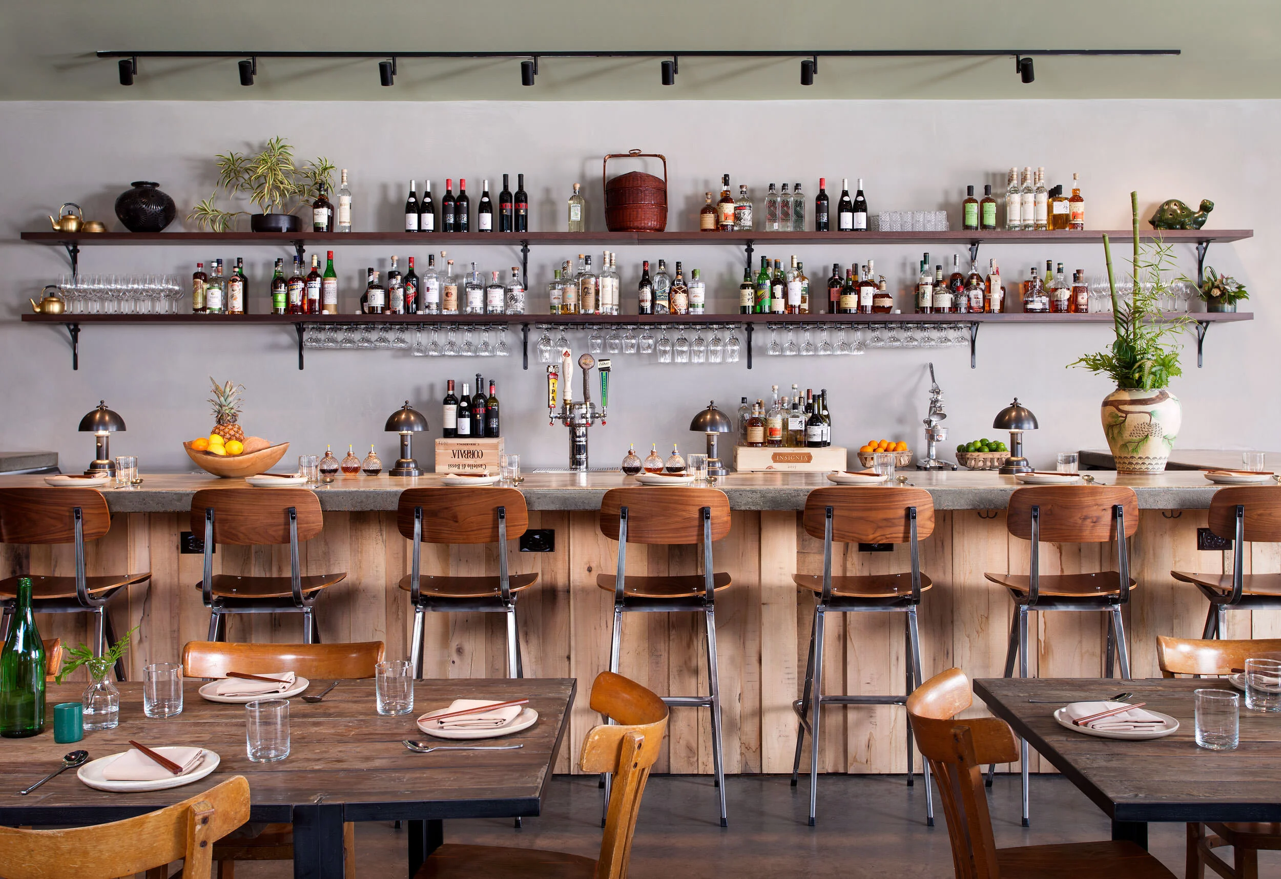  Custom bar with wood front and concrete top at Oseyo Korean Restaurant by Cravotta Interiors. 