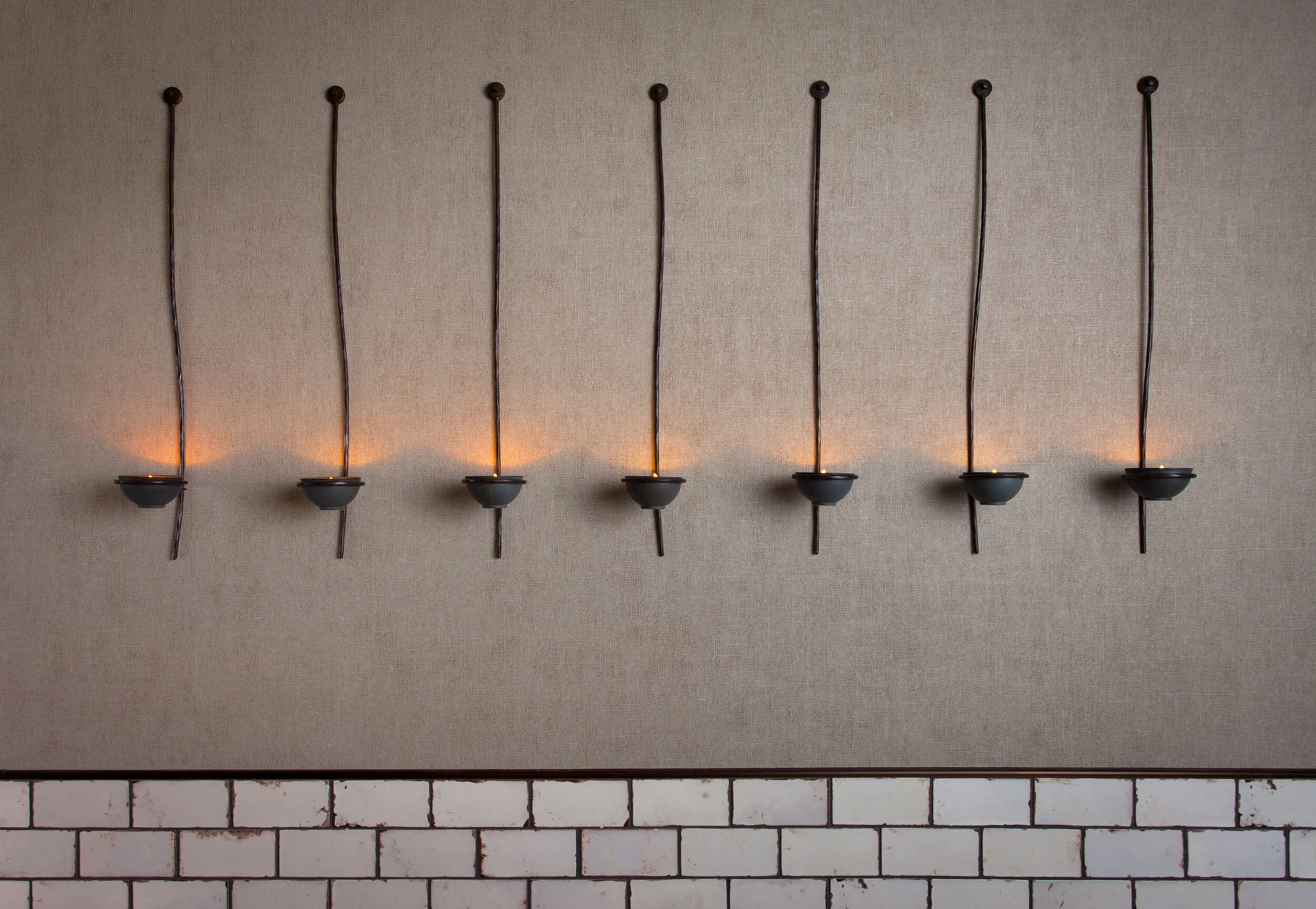  Restroom featuring bronze wire and ceramic candleholders as art at Oseyo, designed by Mark Cravotta. 
