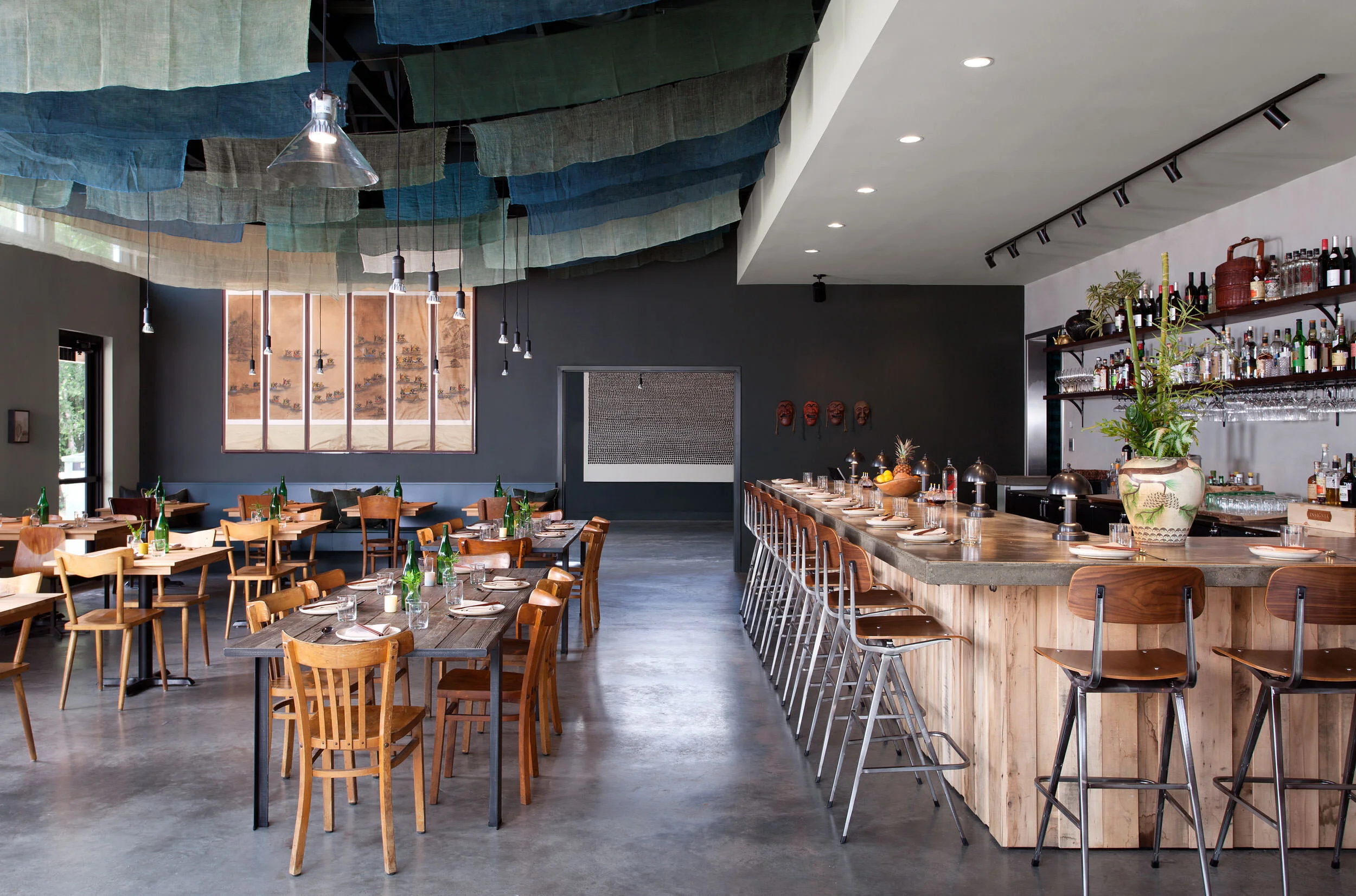  Dining room and bar with antique linen scrim ceiling and custom furniture at Oseyo, designed by Mark Cravotta. 