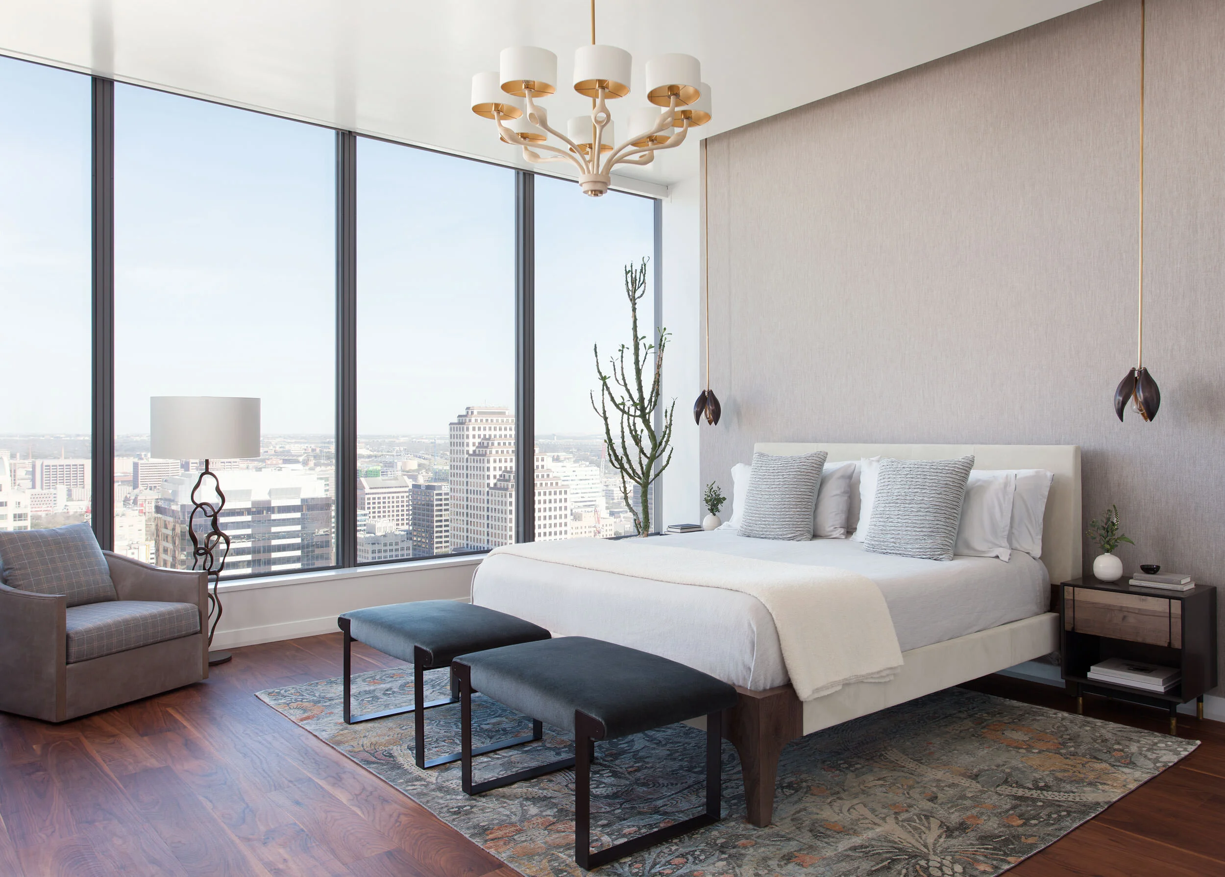  Primary bedroom with Holly Hunt bed, BDDW nightstand, and fabric wallcovering in the W Penthouse, designed by Mark Cravotta. 