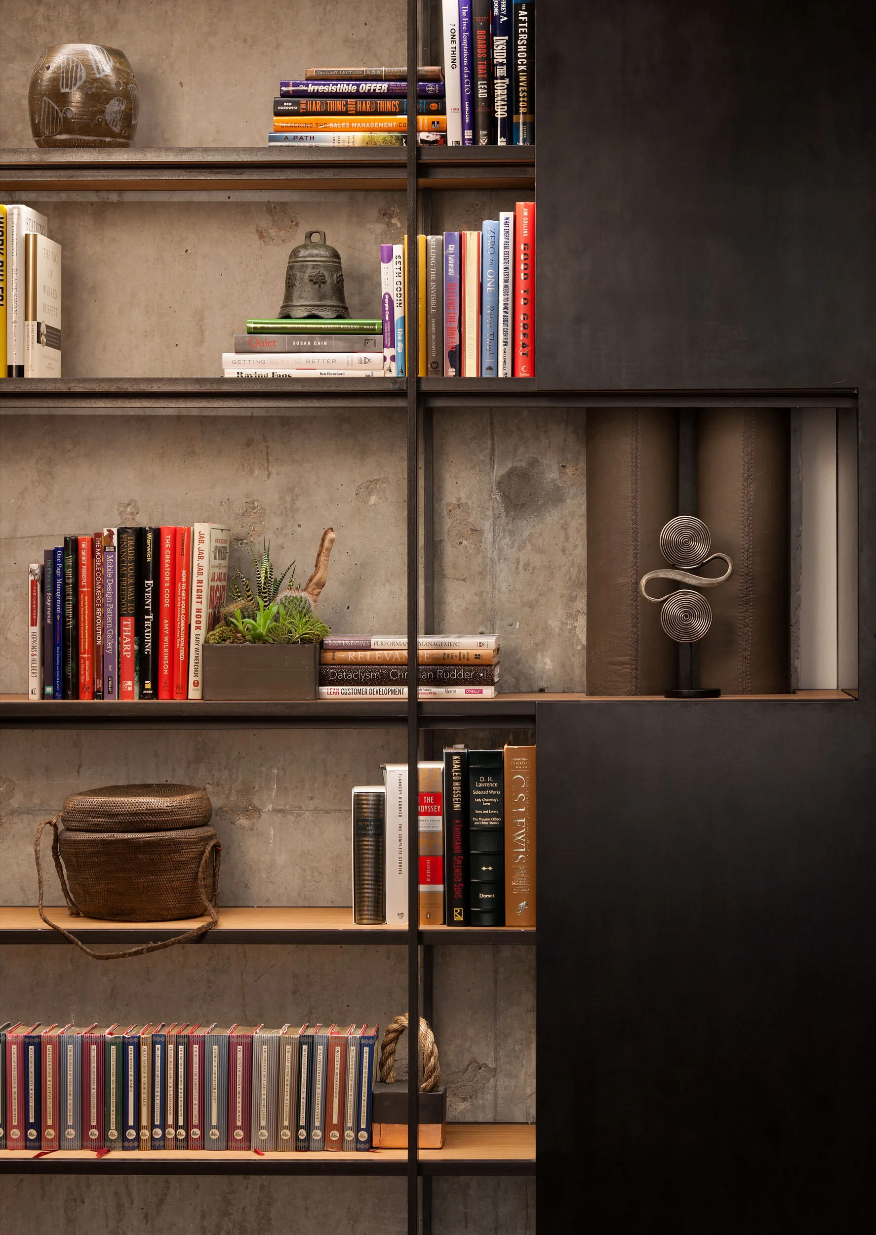  Detail of custom steel shelving and leather desktop against wood paneling in the W Penthouse office, designed by Mark Cravotta. 