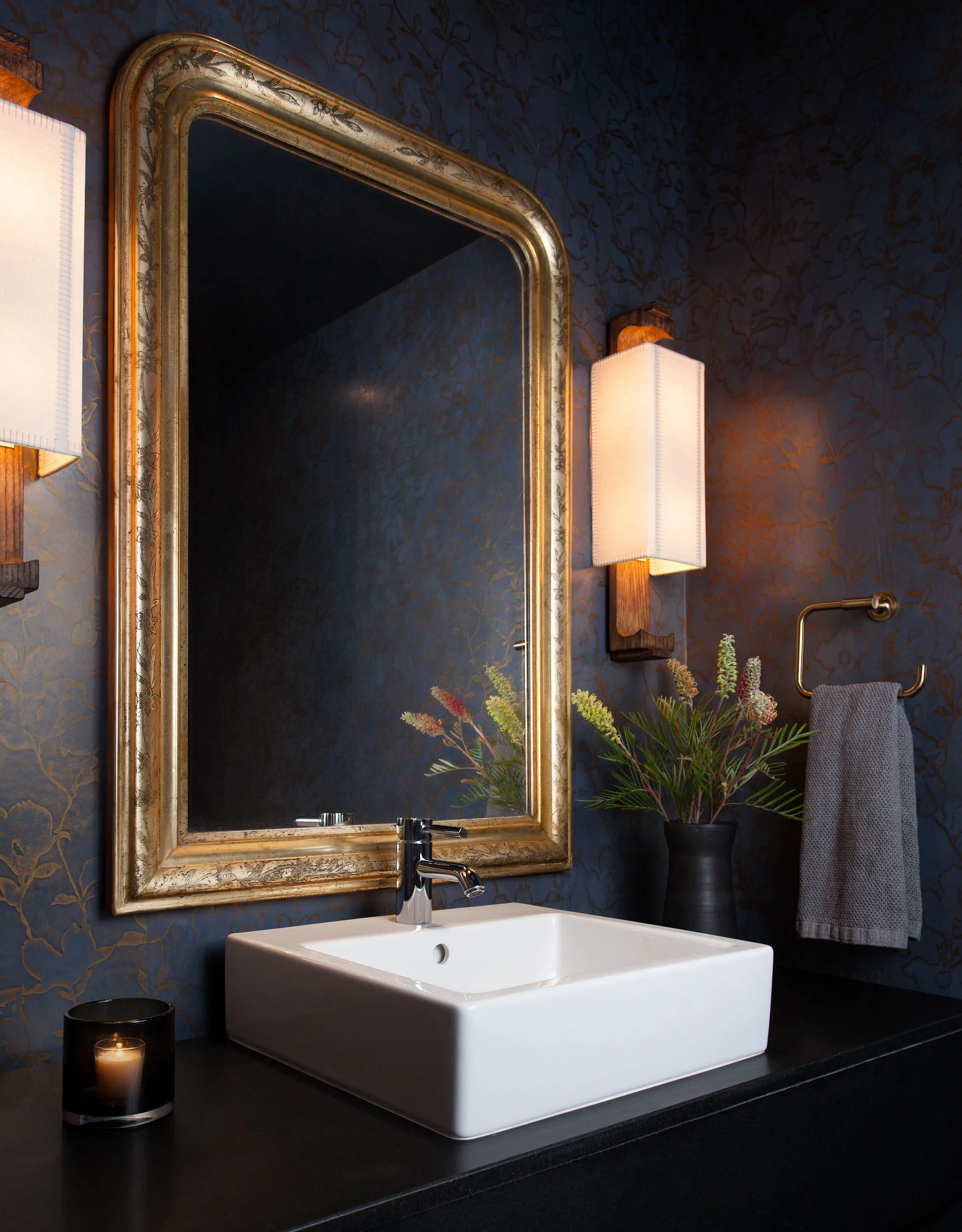  Romantic powder room with custom plaster wallpaper, antique mirror, and Fuse Lighting sconce in the W Penthouse by Cravotta Interiors. 