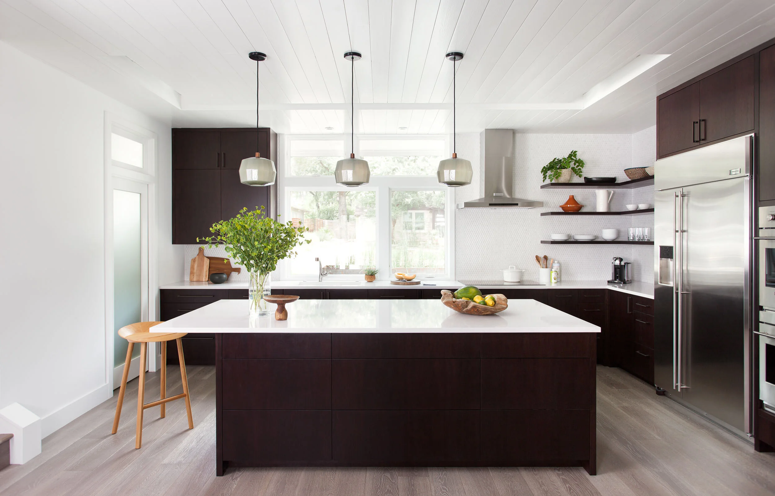  Kitchen with wood ceiling and colorful accents at the Deep Eddy Austin home, designed by Mark Cravotta. 