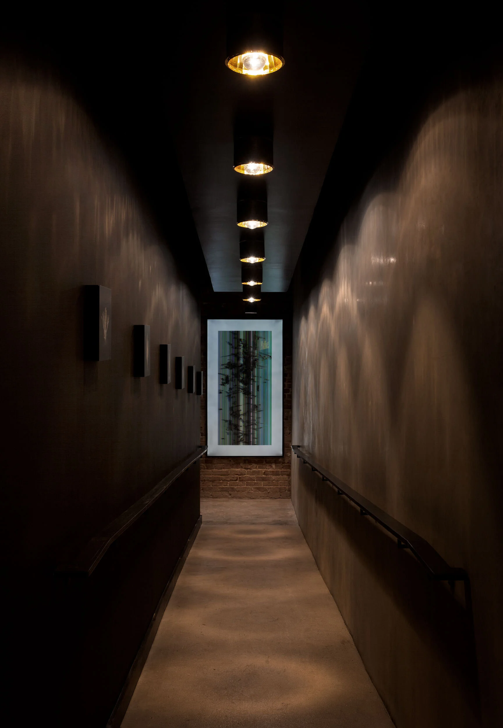  Art-lined hallway in the historic Maverick Restaurant, designed by Mark Cravotta. 