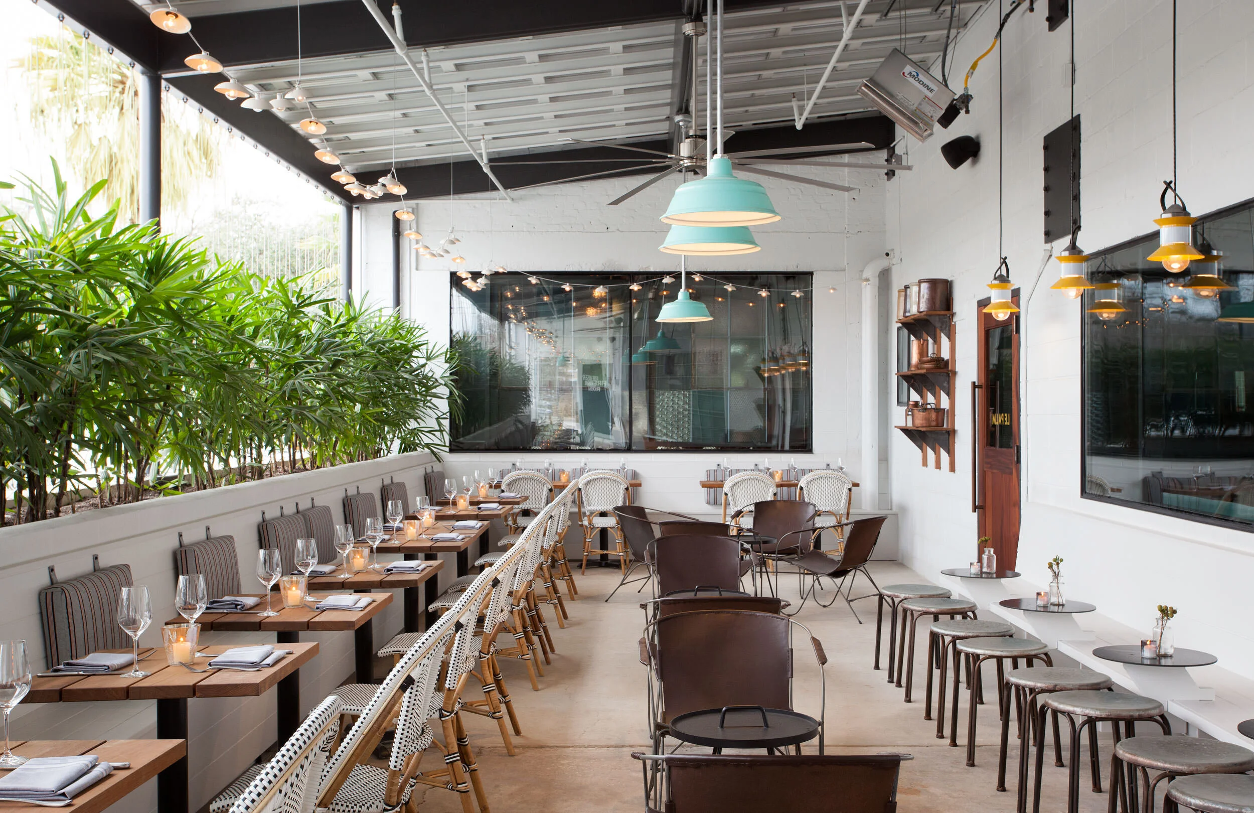  Outdoor patio dining terrace with custom furniture at the Maverick by Cravotta Interiors. 