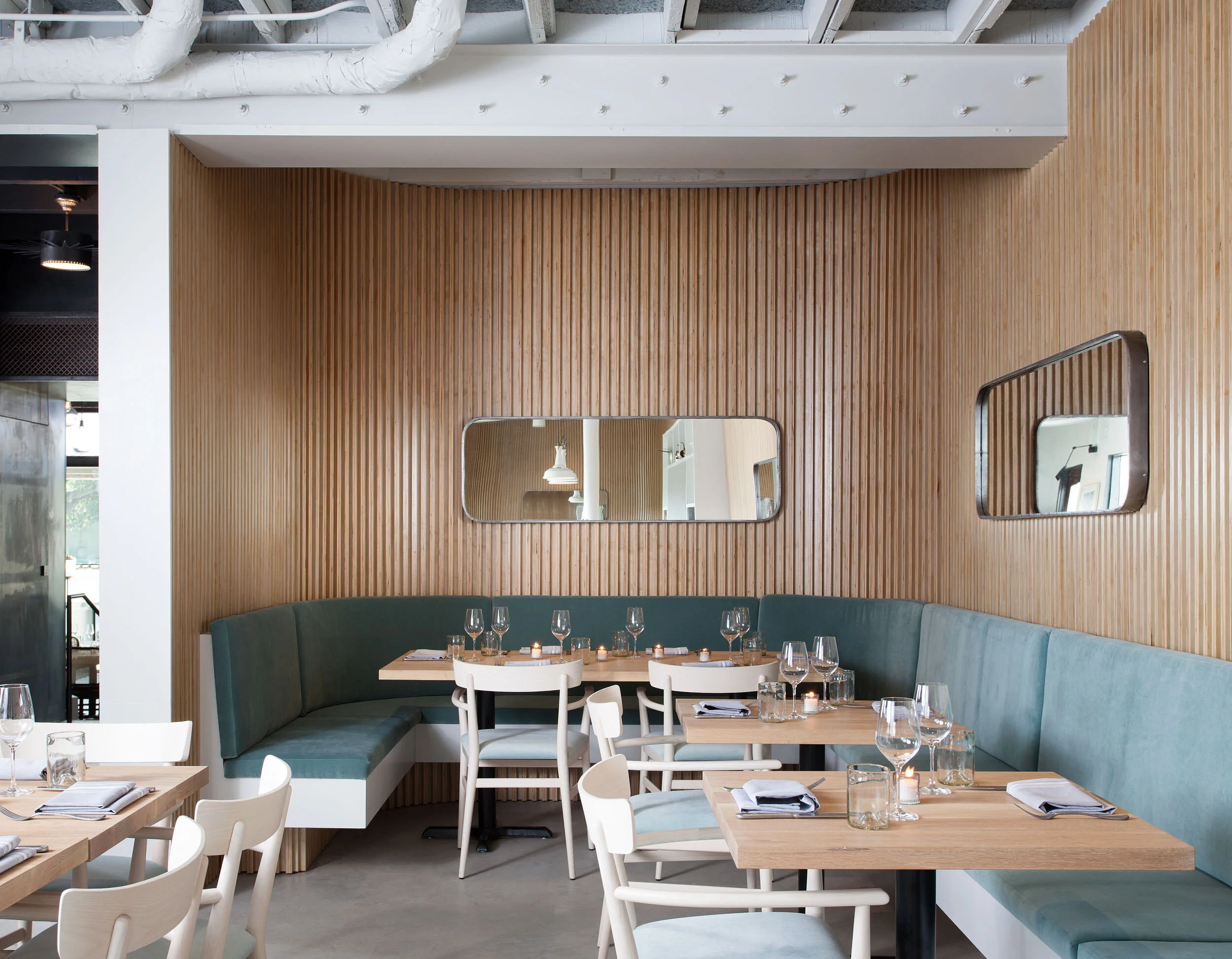  Banquette seating in the bright garden room at the Maverick Restaurant, designed by Mark Cravotta. 