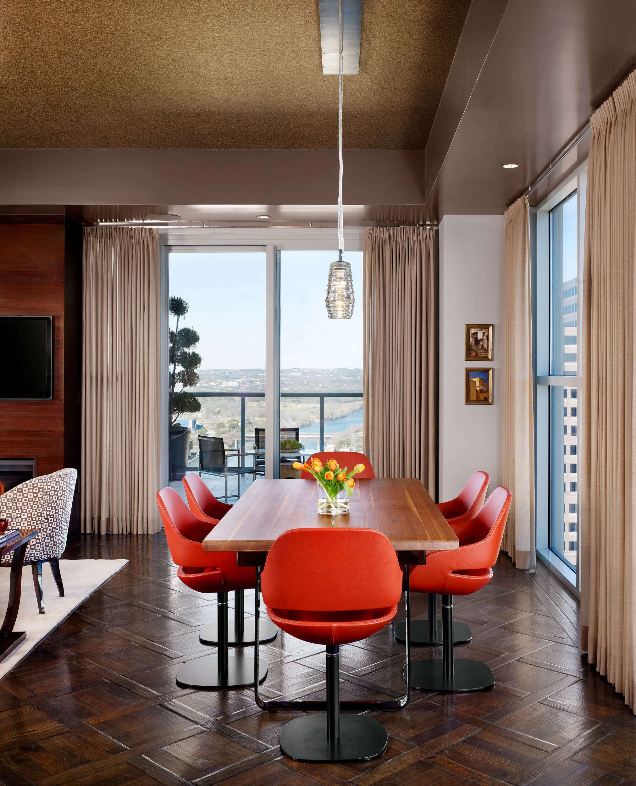  Breakfast area with red leather dining chairs in the Four Seasons Penthouse, designed by Mark Cravotta. 