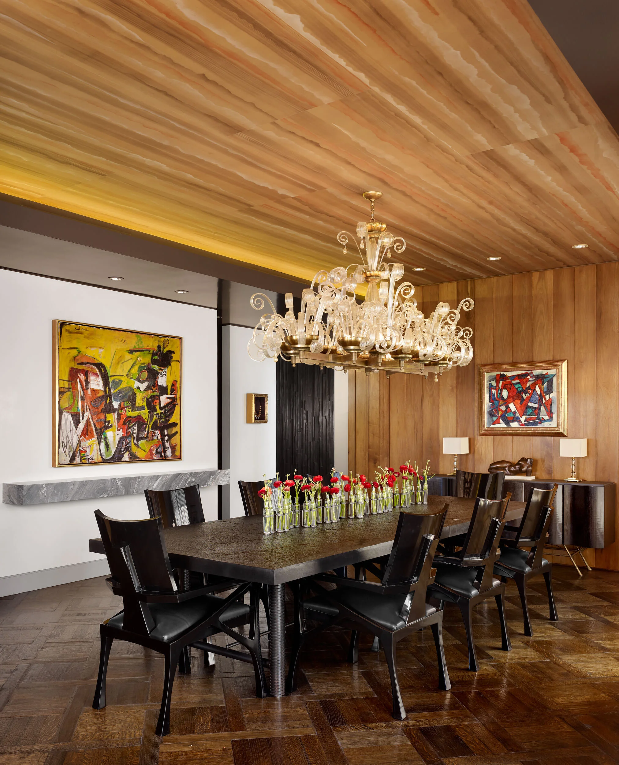  Dining room with antique Deco chandelier and leather mosaic walls in the Four Seasons Penthouse by Cravotta Interiors. 