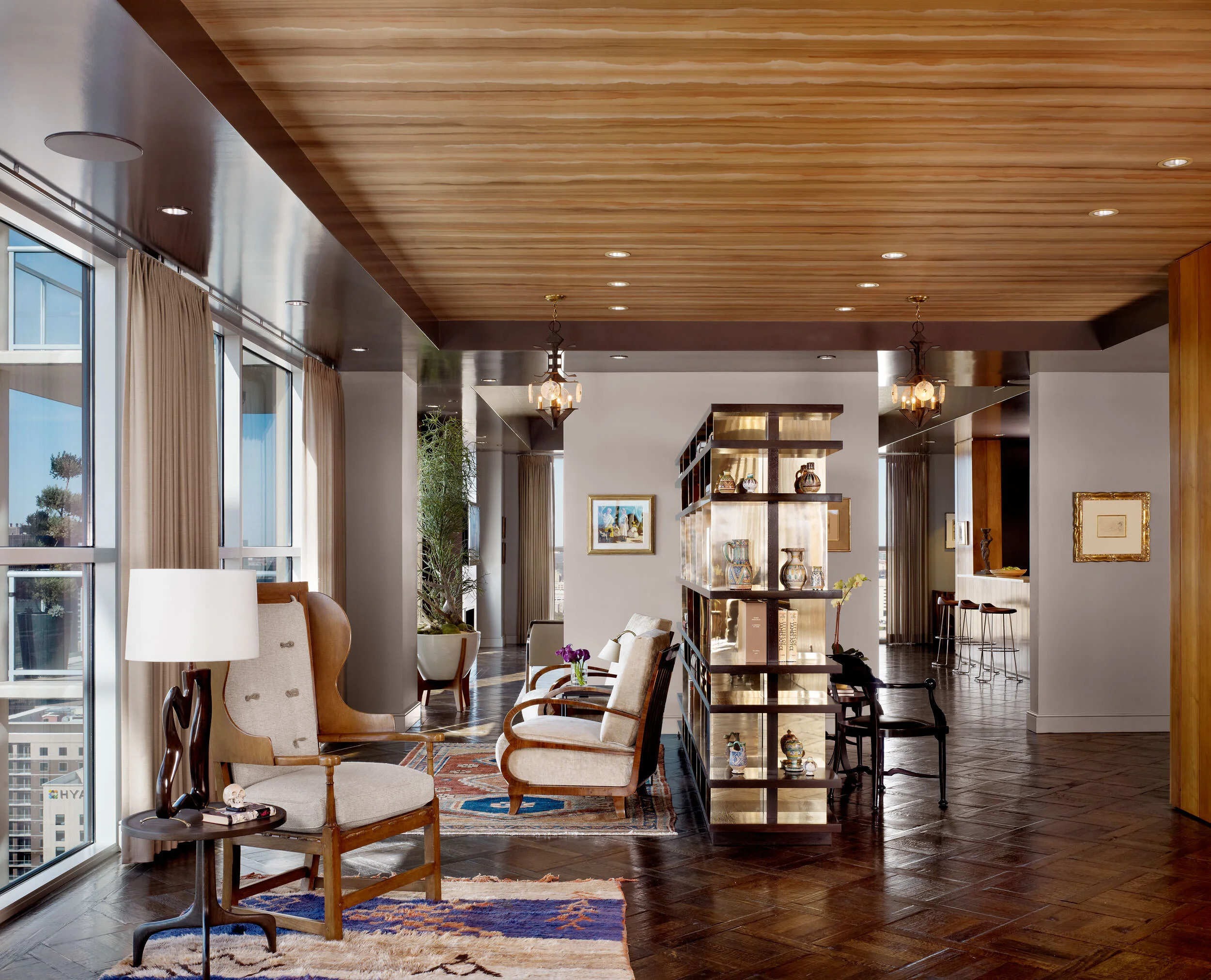  Sitting area beneath antique pendant and walnut paneling at the Four Seasons Penthouse, designed by Mark Cravotta. 