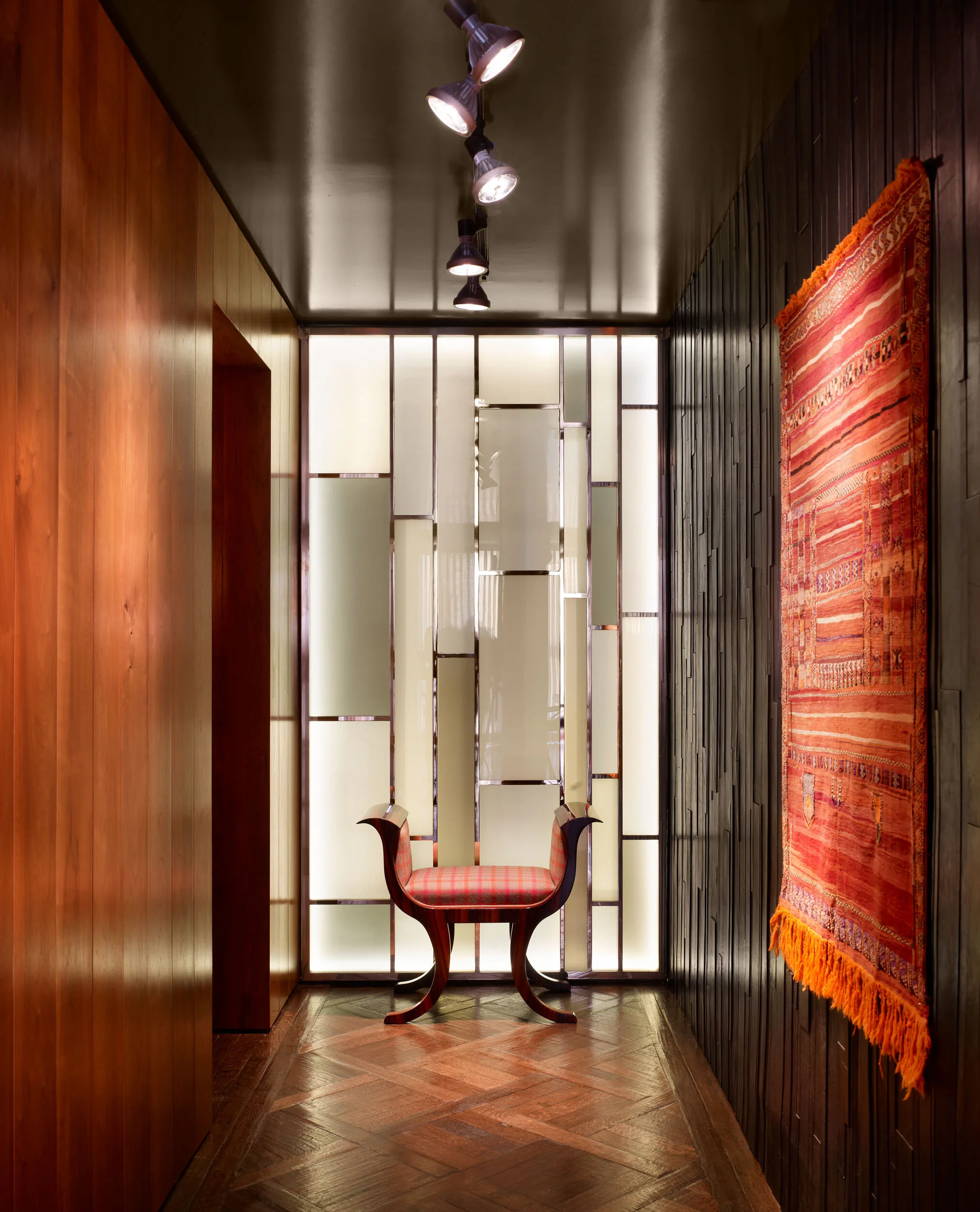  Hallway to powder room with custom bronze and glass wall and leather mosaic walls, designed by Mark Cravotta. 