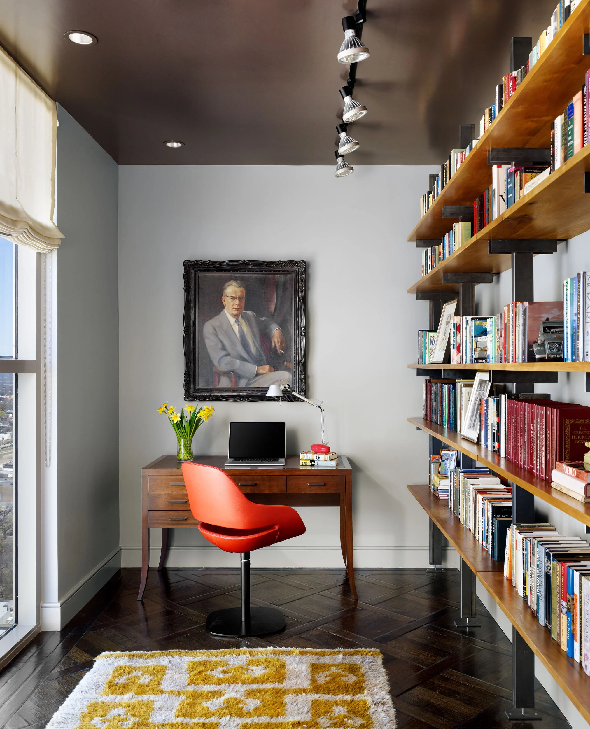  Library office with custom shelves, red chair, custom desk, and Moroccan rug at the Four Seasons Penthouse by Cravotta Interiors. 