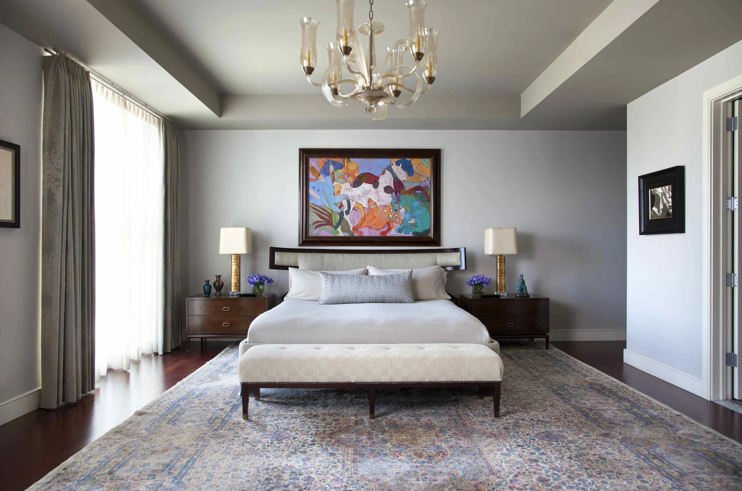  Bedroom with antique rug and chandelier at Northumberland, Austin, designed by Mark Cravotta. 