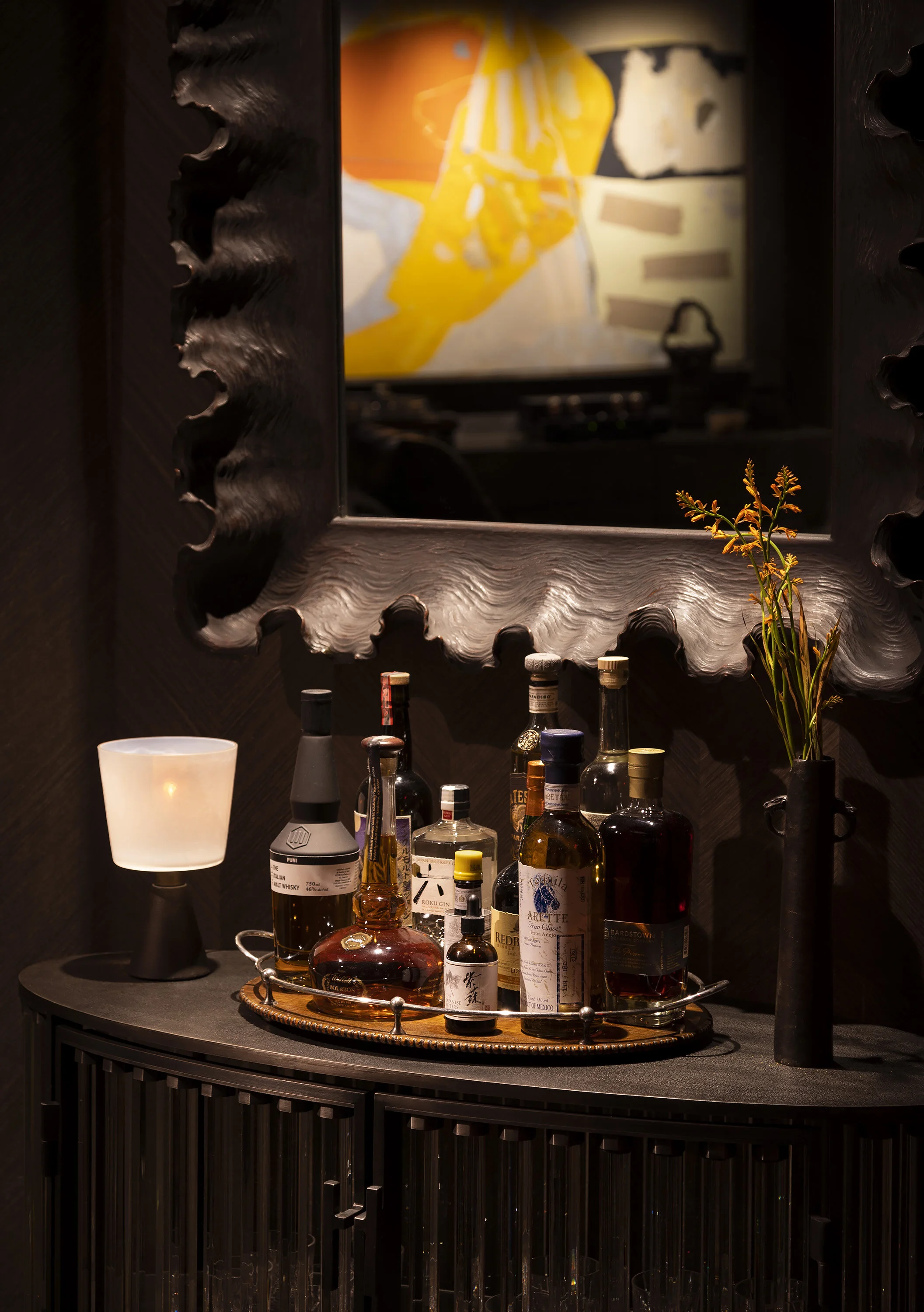  Close-up of the steel and glass bar with curated glassware at Kips Bay, designed by Mark Cravotta. 