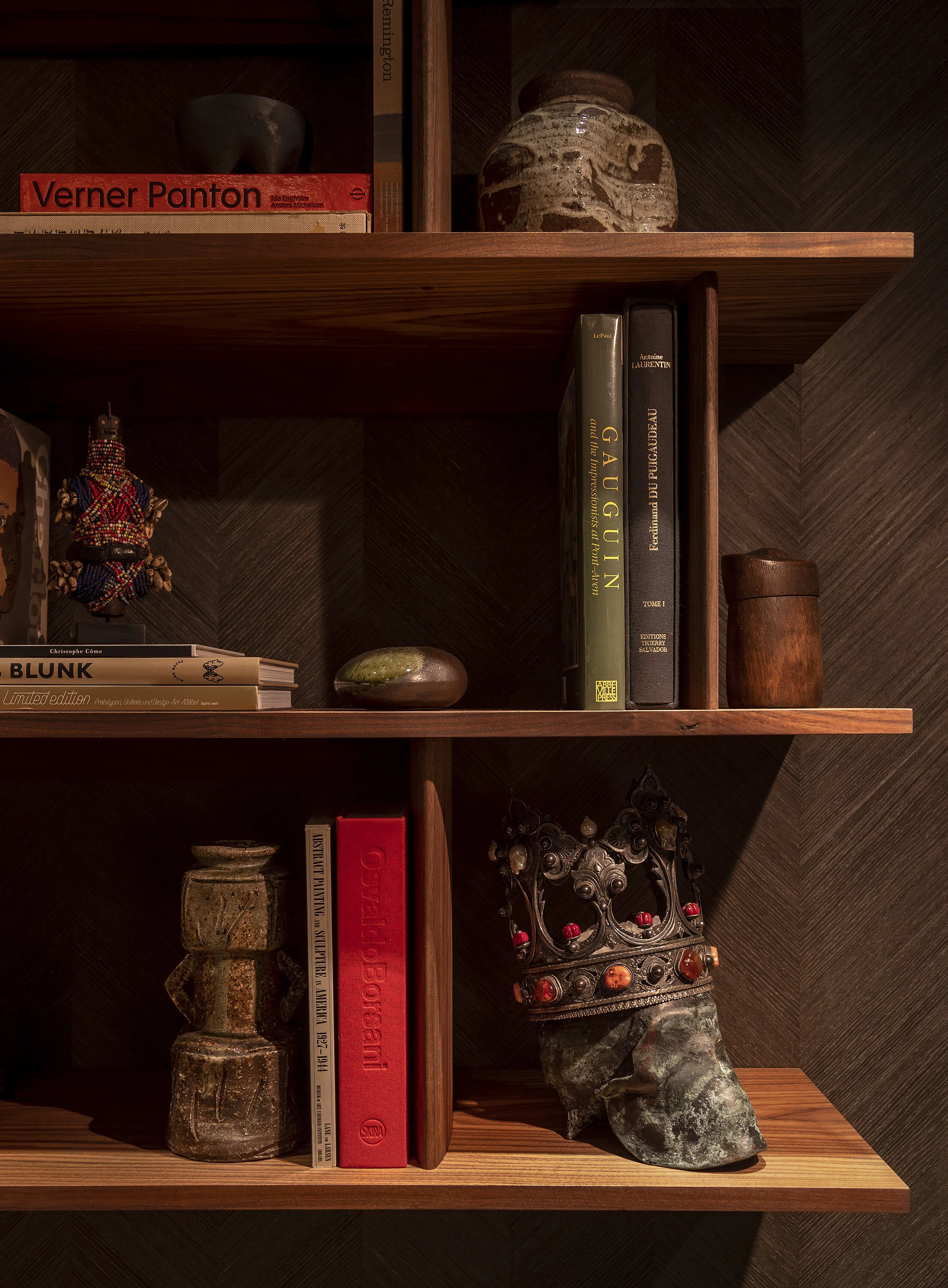  Curated shelf vignette against wood veneer walls at the Kips Bay Show House by Cravotta Interiors. 