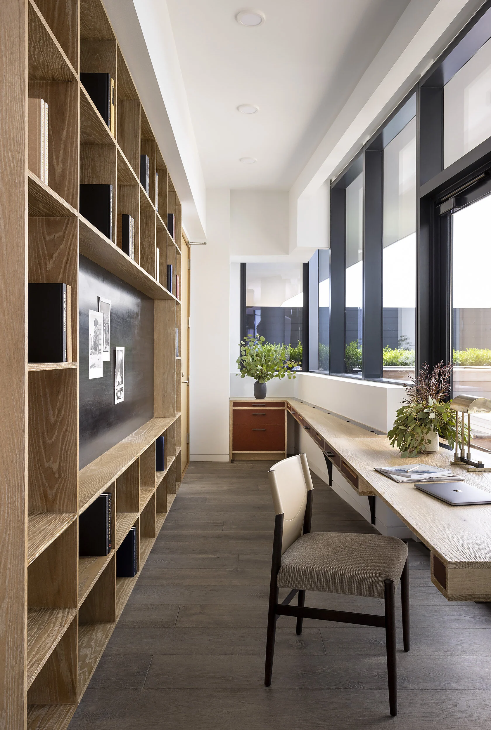  Office nook with custom oak and leather cabinetry and built-in desk at the Proper Penthouse by Cravotta Interiors. 