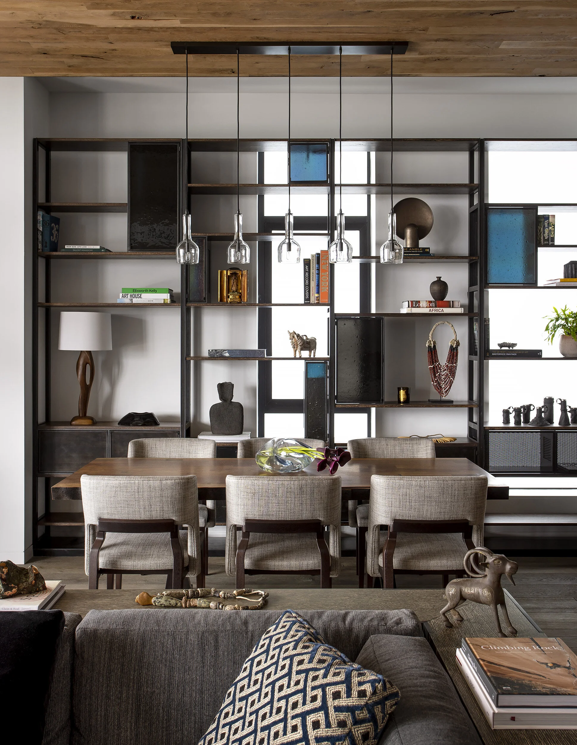 Dining area with curated object collection on custom shelving in the Proper Penthouse, designed by Mark Cravotta. 