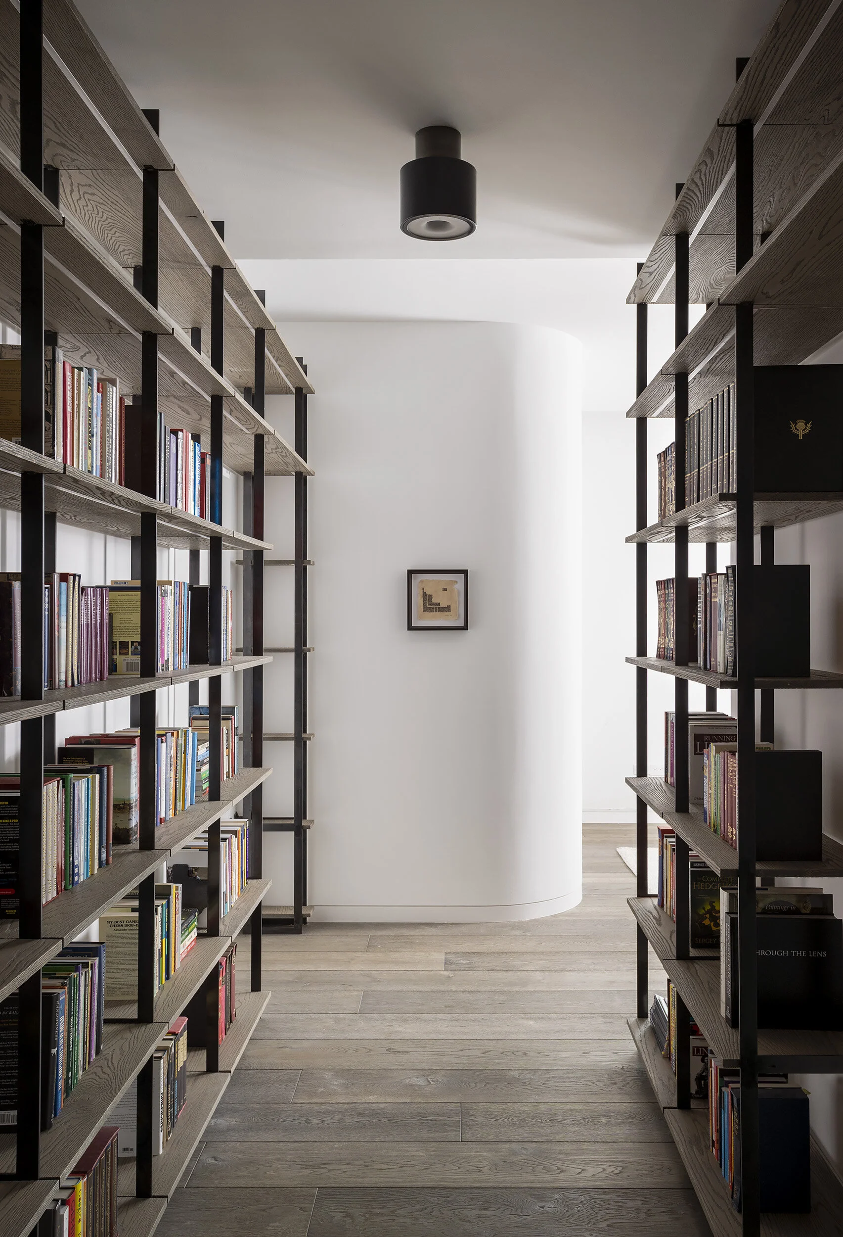  Custom oak and steel shelving at the entry to the primary bedroom in the Proper Penthouse, designed by Mark Cravotta. 