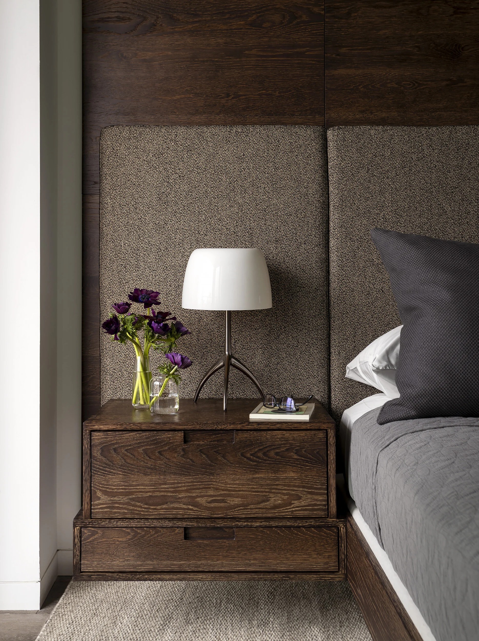  Detail of dark oak headboard and nightstand in the Proper Penthouse primary suite, designed by Mark Cravotta. 