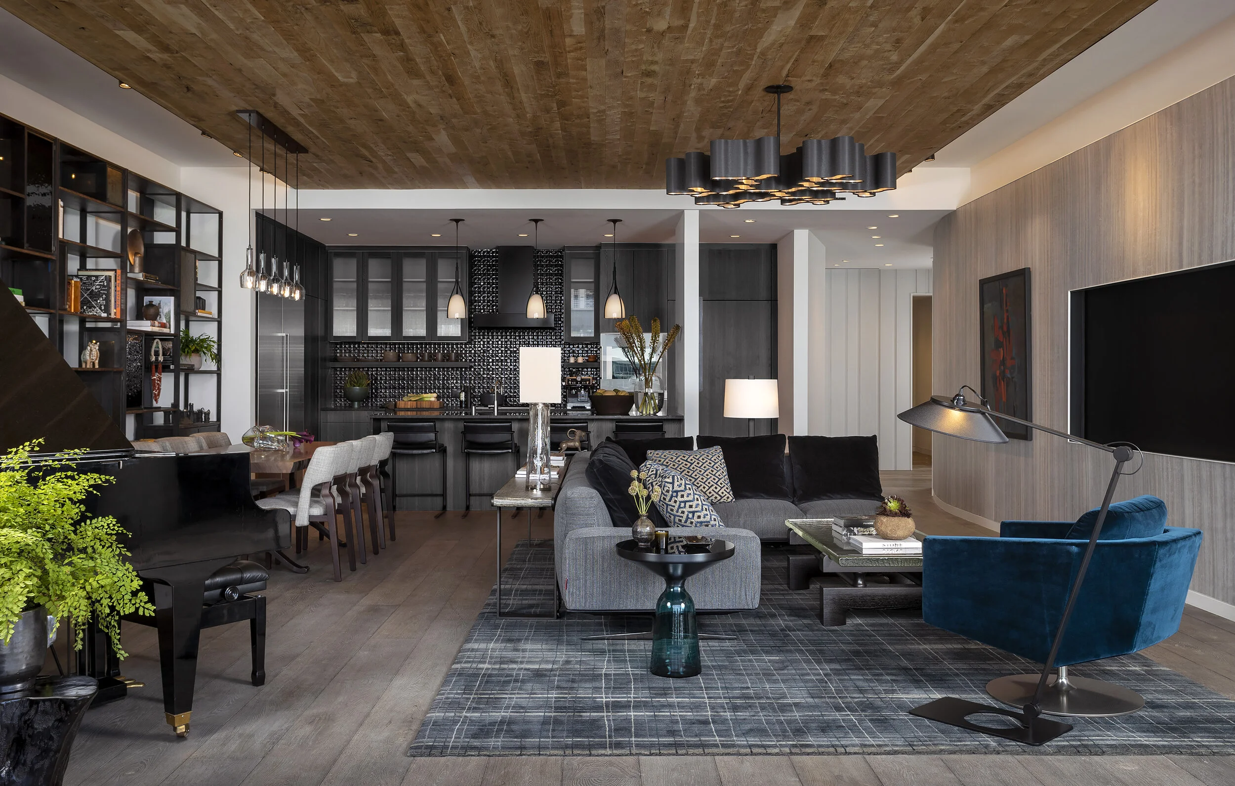  View through the living room to dark wood kitchen cabinetry in the Proper Penthouse, designed by Mark Cravotta. 