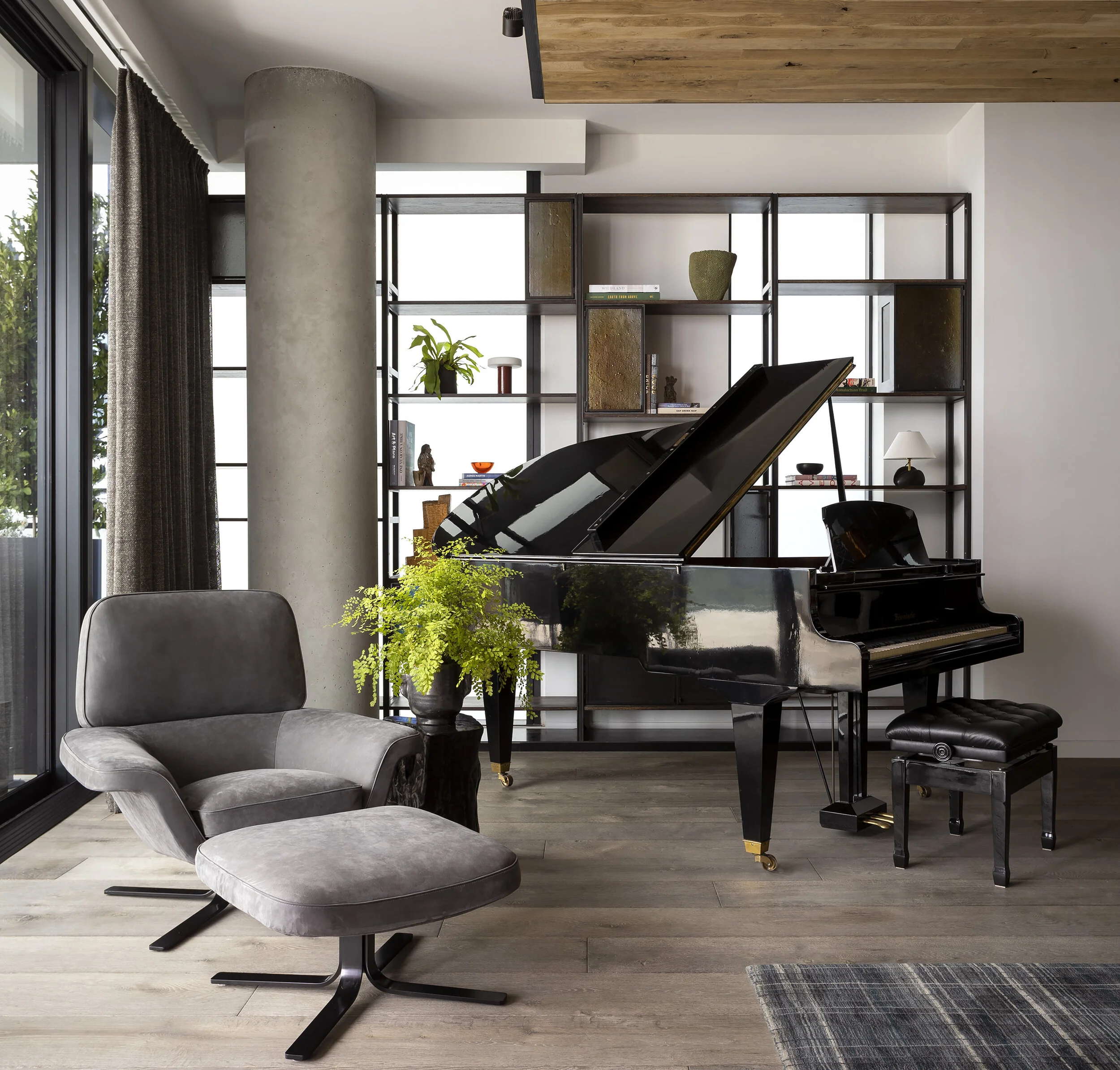  Piano and custom shelving beneath the wood ceiling in the Proper Penthouse living room by Cravotta Interiors. 