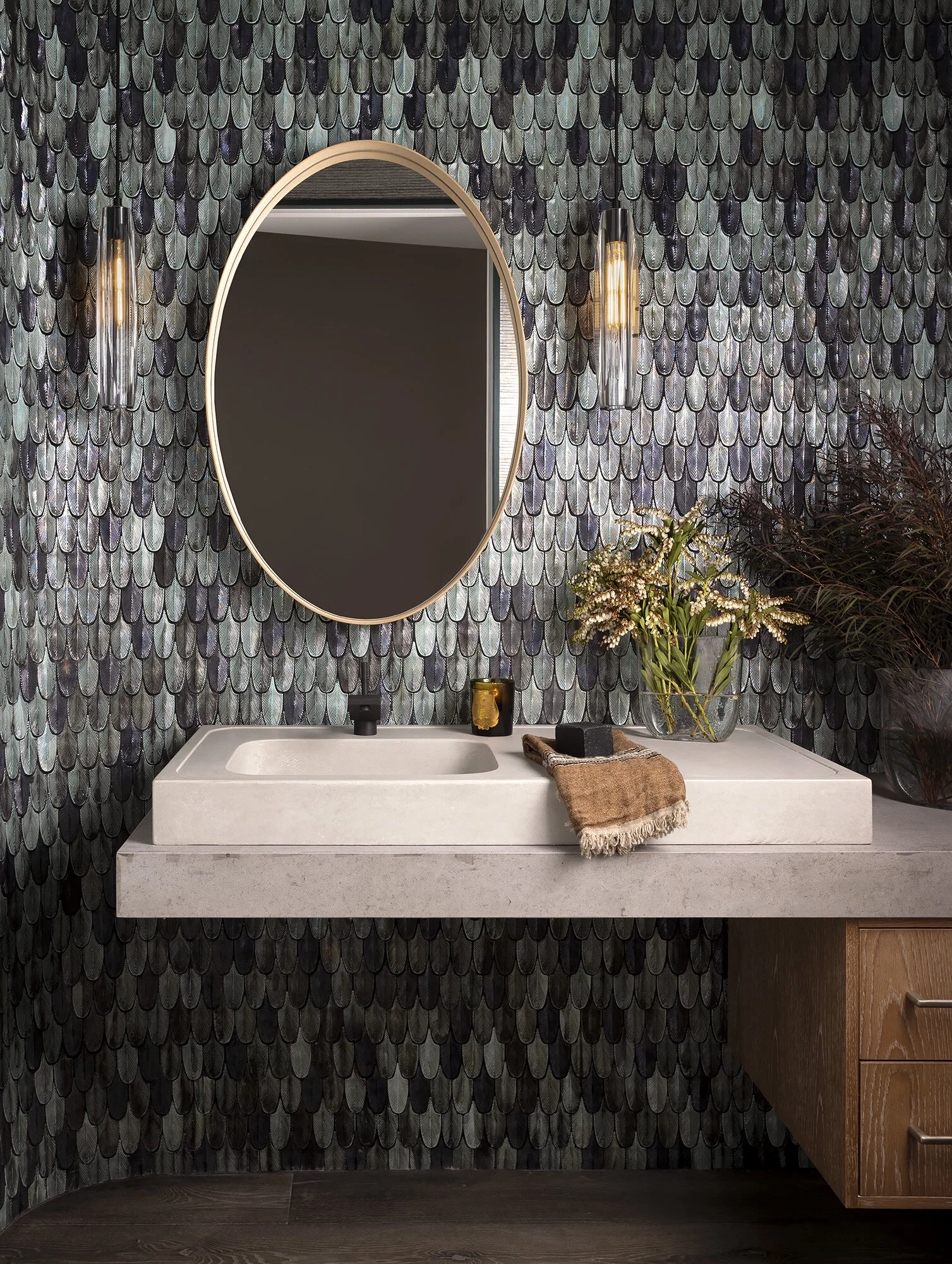  Powder room with handmade feather-pattern tile and custom stone and concrete vanity at the Proper Penthouse, designed by Mark Cravotta. 
