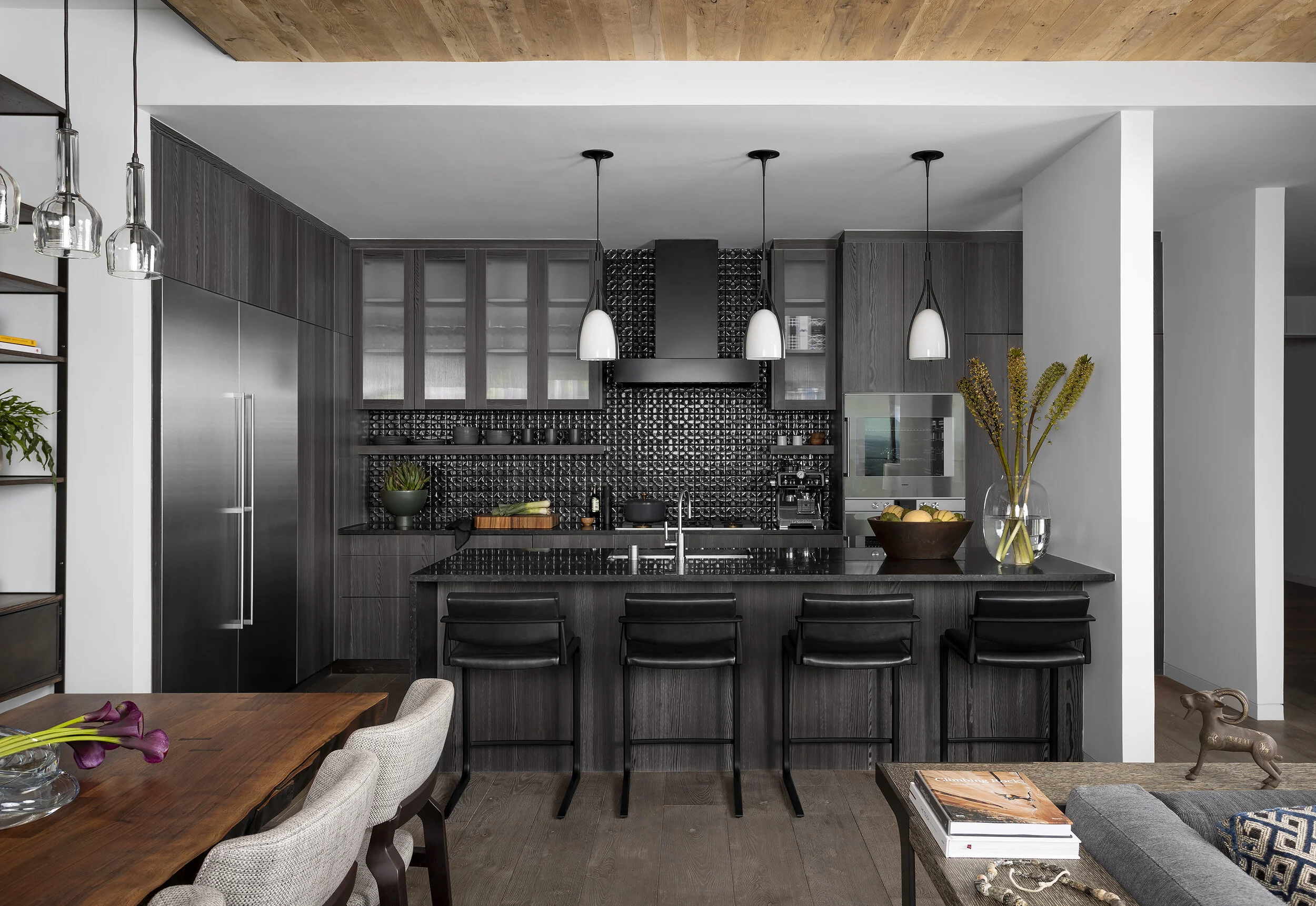  Kitchen with dark wood cabinets and wood ceiling in the Austin Proper Penthouse by Cravotta Interiors. 