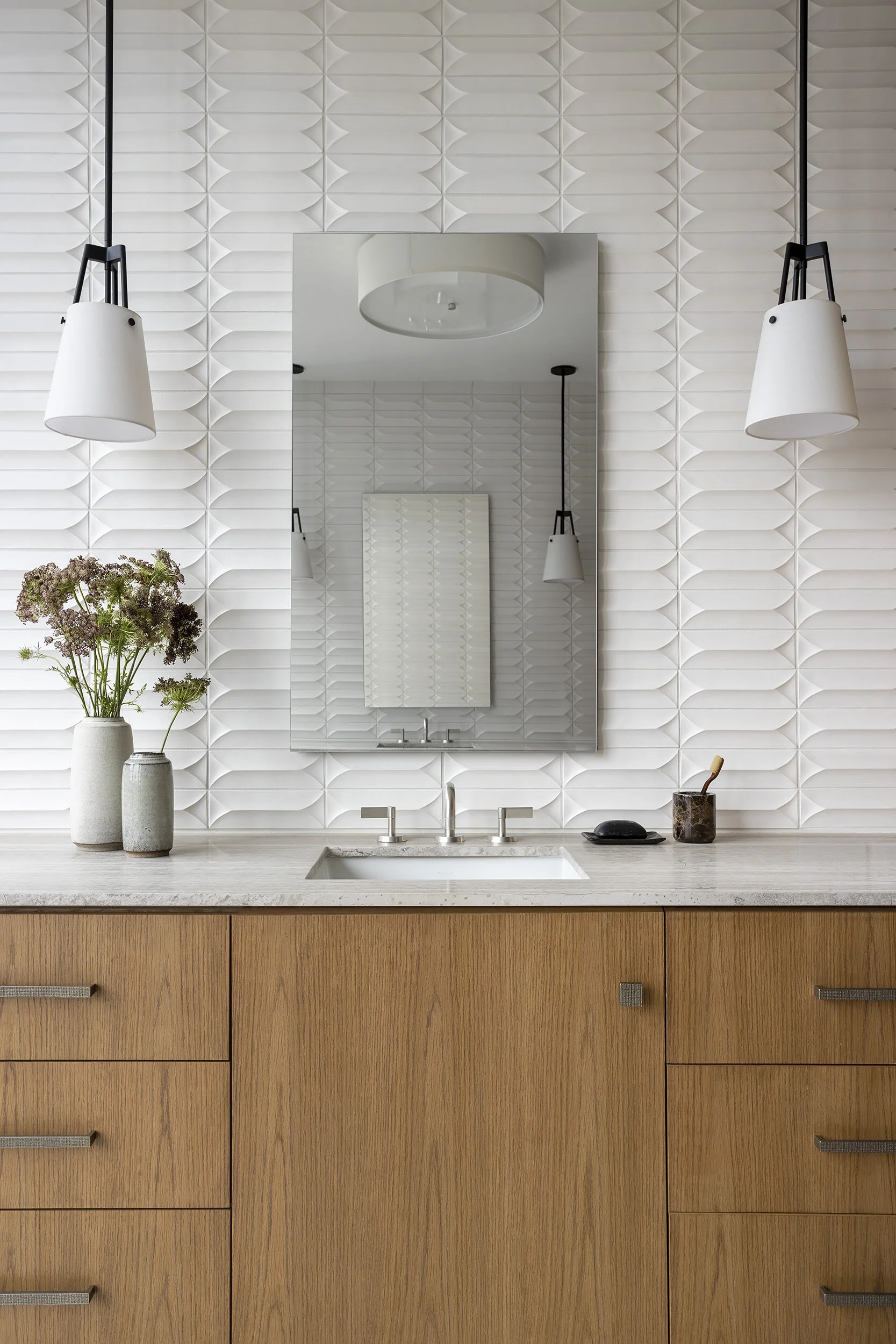  Handmade tile walls and travertine floor detail in the Proper Penthouse primary bath, designed by Mark Cravotta. 