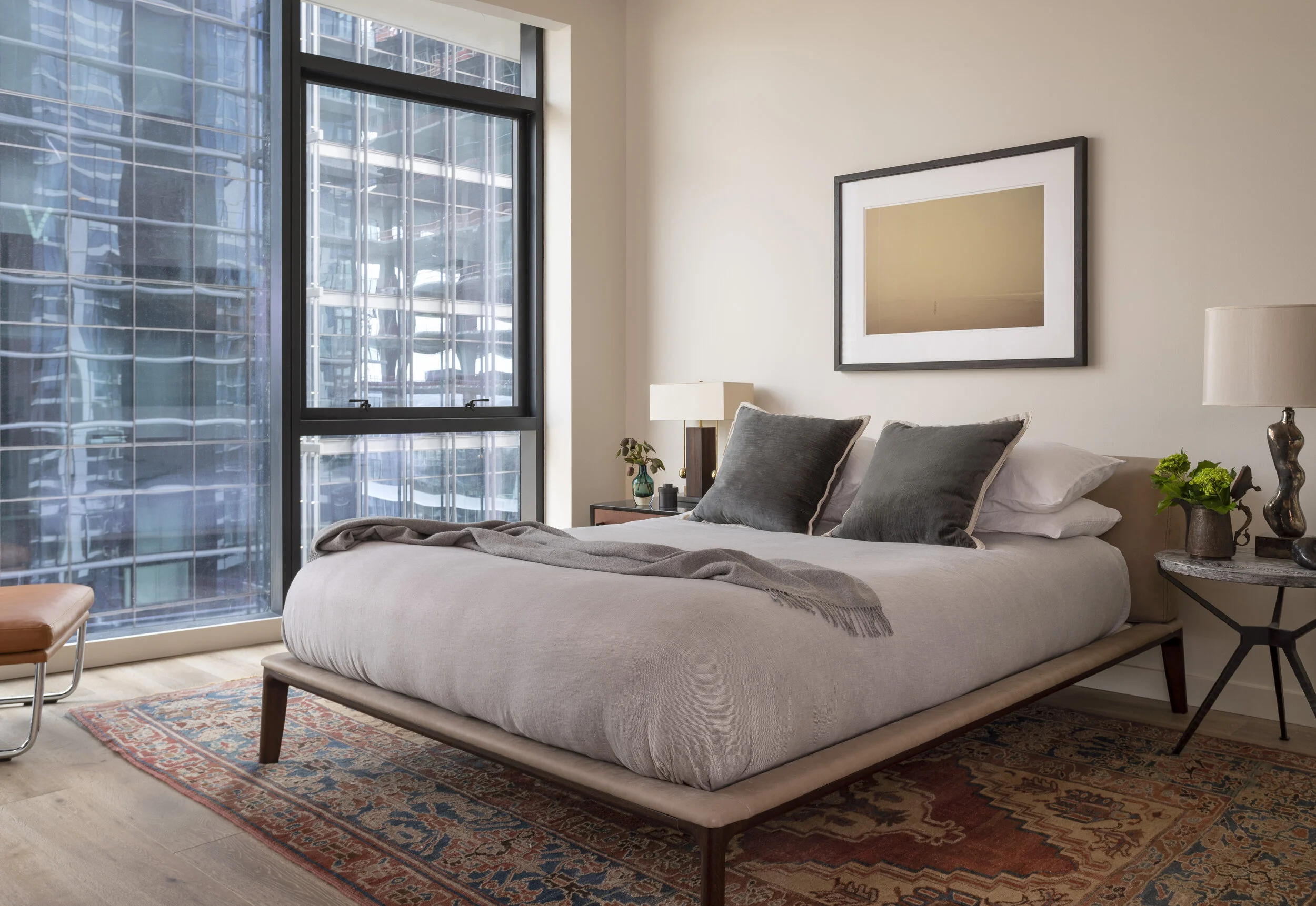  Bedroom with antique rug and leather bed at the Proper Residence, designed by Mark Cravotta. 