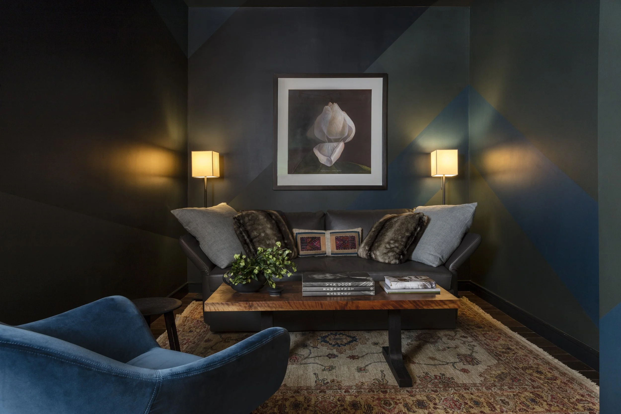  Dark, moody entry lounge with antique rug at Stella NYC, designed by Mark Cravotta. 