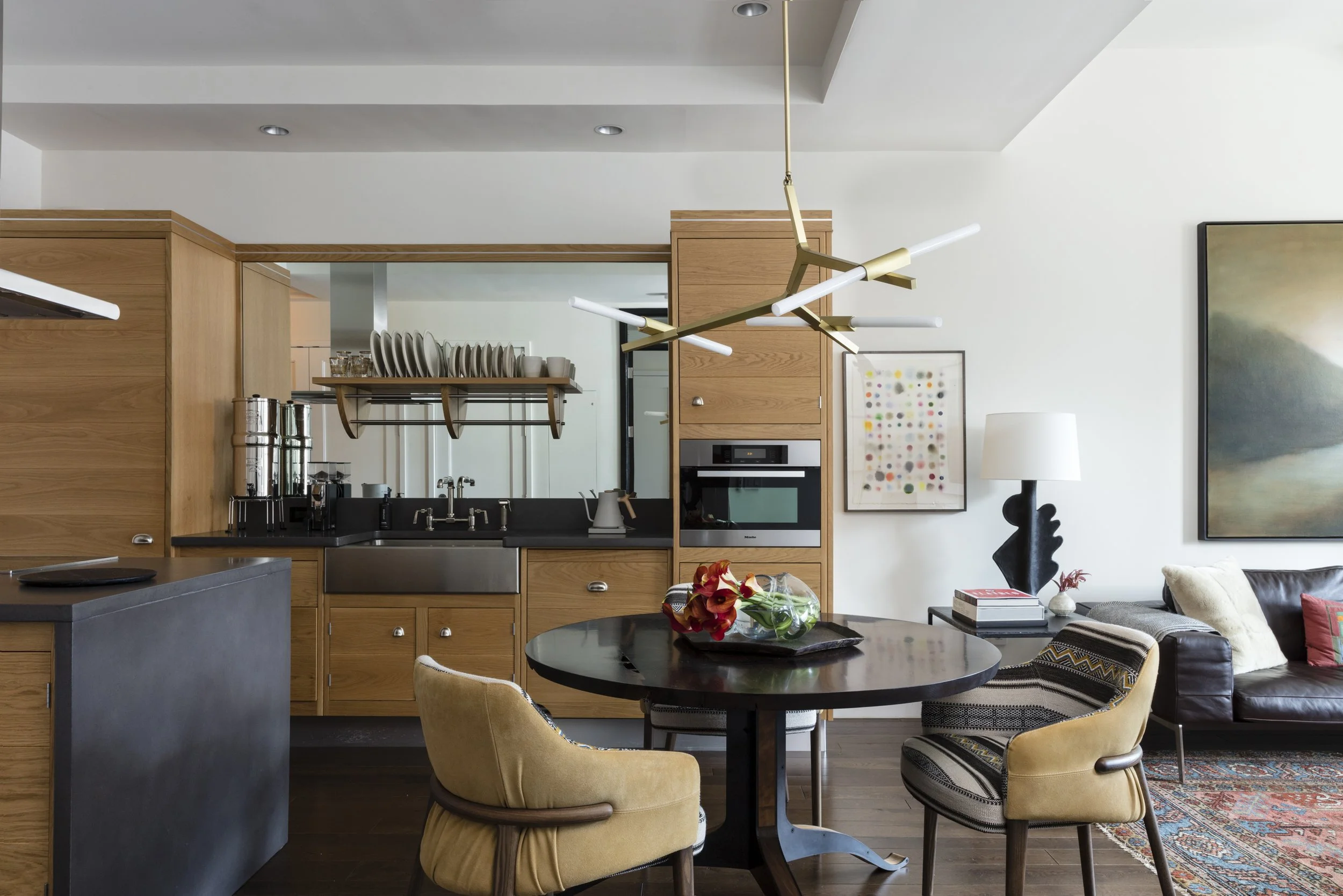  Kitchen with oak cabinets and concrete countertops at Stella NYC, designed by Mark Cravotta. 