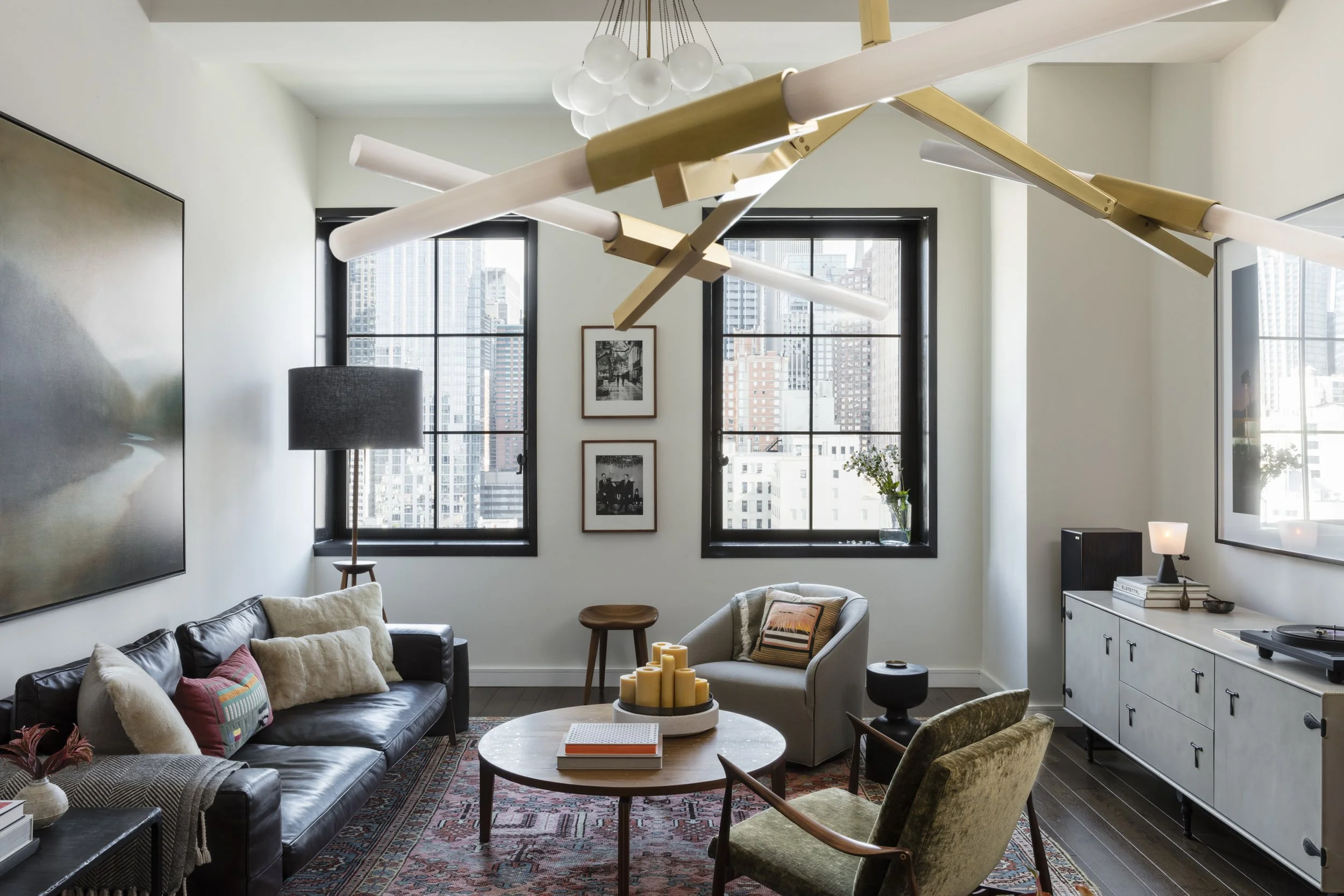  Side view of the Stella NYC living room showing layered textiles and art by Cravotta Interiors. 