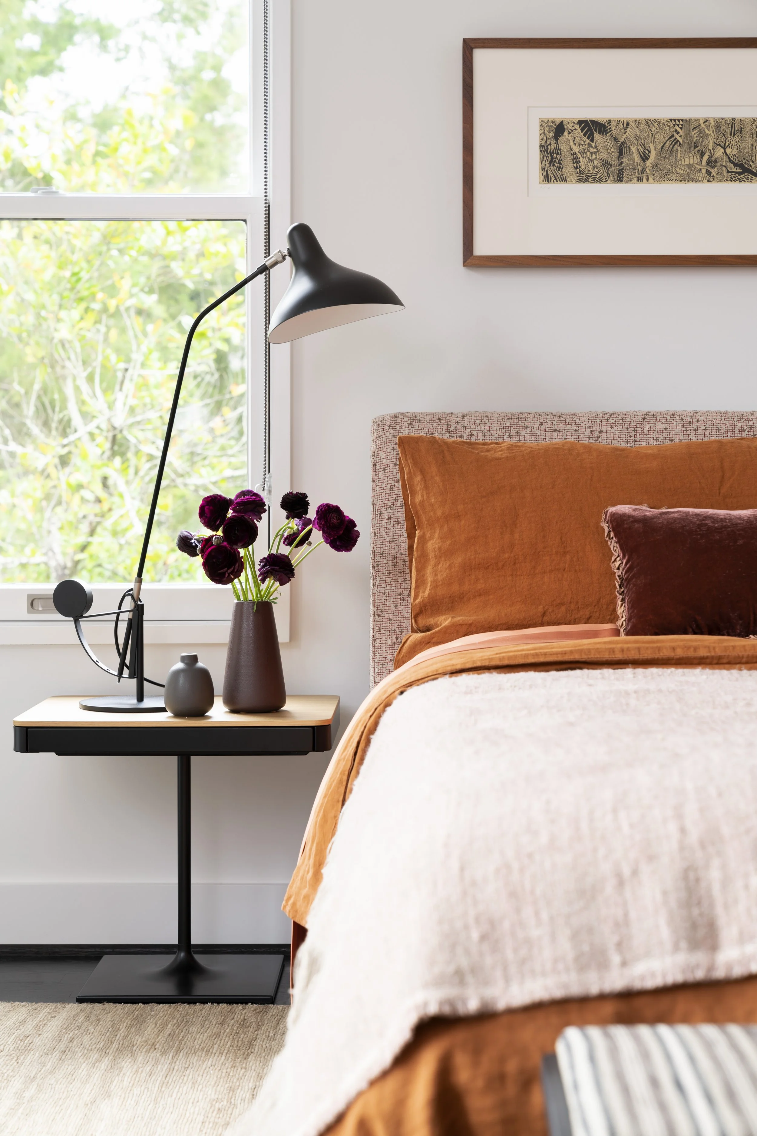  Bright, airy guest bedroom with bold orange accents in the Boulevard Oaks Houston home, designed by Mark Cravotta. 
