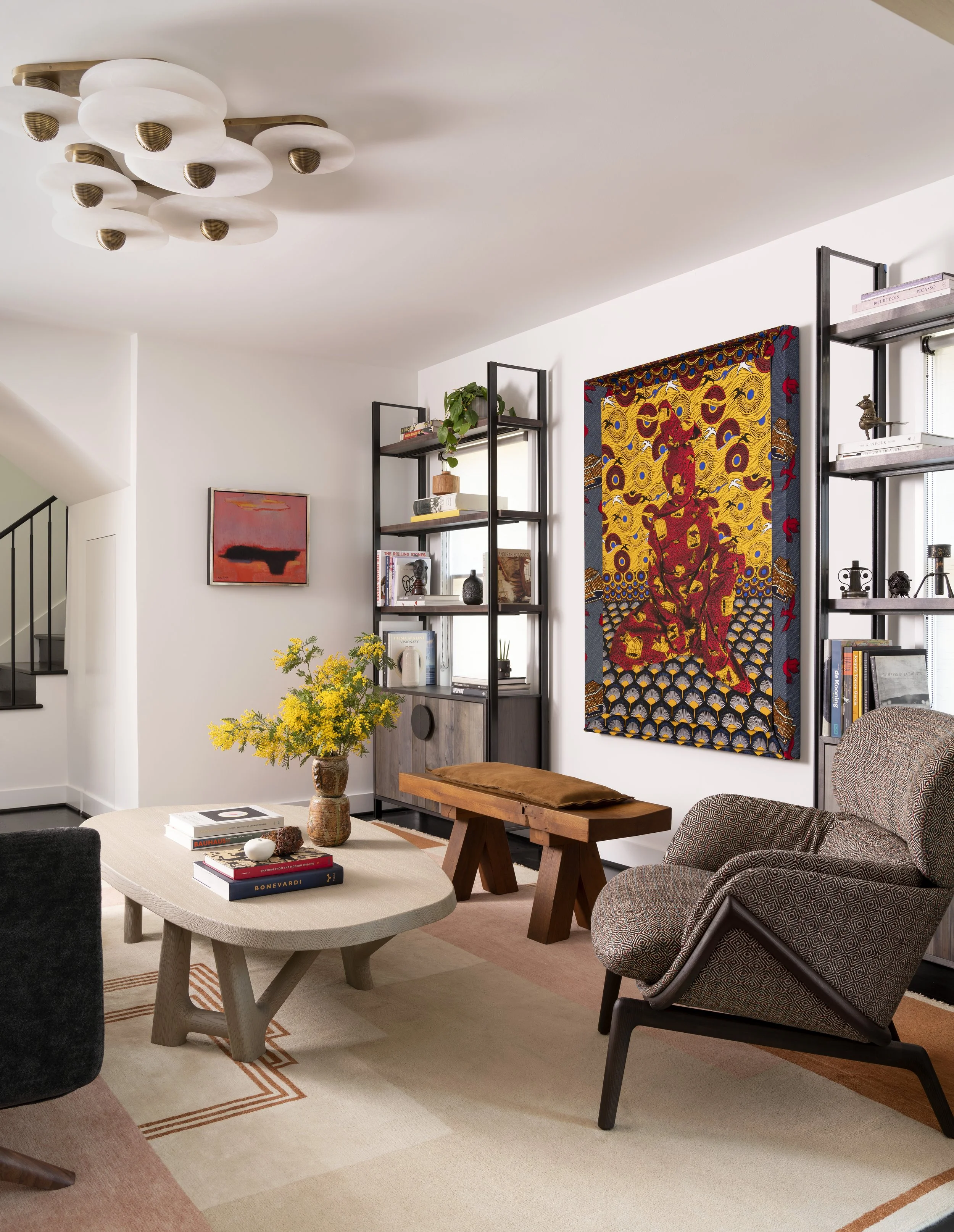  Art-filled living room with custom bookshelves, custom rug, and Alia Ali artwork at Boulevard Oaks, designed by Mark Cravotta. 
